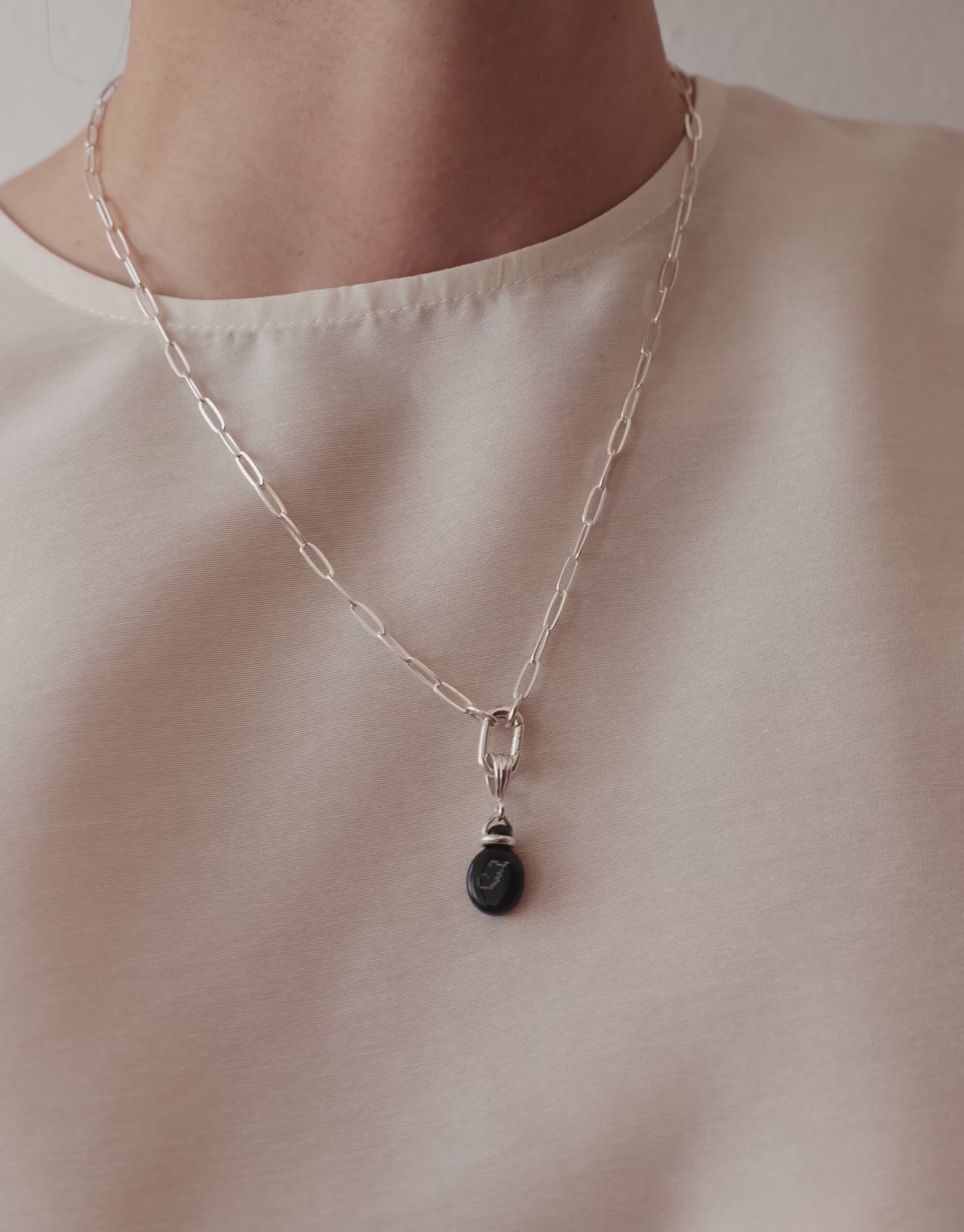LAS Oval Pendant in motion, worn on the model. Upcycled glass Eco Gems in sterling silver, handmade in Los Angeles. LAS Oval Pendant by CLED.