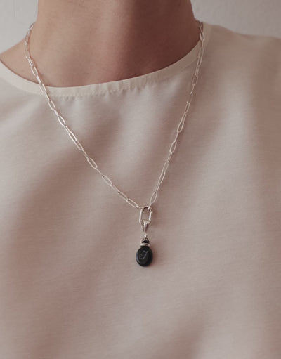 LAS Oval Pendant in motion, worn on the model. Upcycled glass Eco Gems in sterling silver, handmade in Los Angeles. LAS Oval Pendant by CLED.