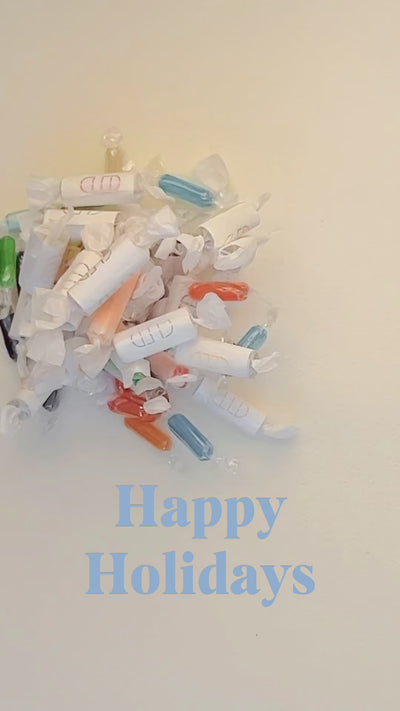 The video starts with festive "Happy Holidays" visuals, setting a cheerful tone. It transitions to a step-by-step demonstration of how the Fortune Eco Gems are crafted, showcasing the care and creativity behind the process. The final scene highlights people joyfully opening their Fortune Eco Gems, revealing personalized fortune messages inside, and sharing heartfelt reactions. The video wraps up with a tagline like, "Spread joy and sustainable luck this holiday season with Fortune Eco Gems!
