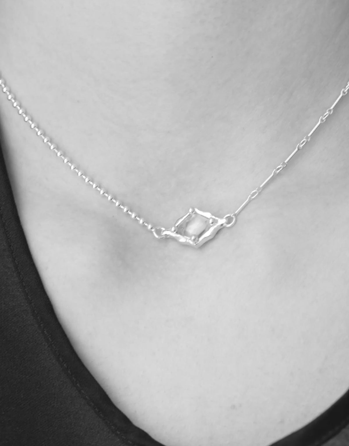 Interlace Necklace in motion, worn on the model. Upcycled glass Eco Gems in sterling silver, handmade in Los Angeles. Interlace Necklace by CLED.
