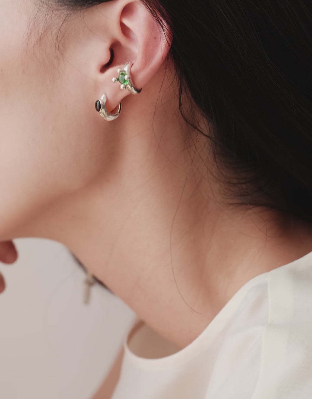 Picot Ear Cuff in motion, worn on the model. Upcycled glass Eco Gems in sterling silver, handmade in Los Angeles. Picot Ear Cuff by CLED.