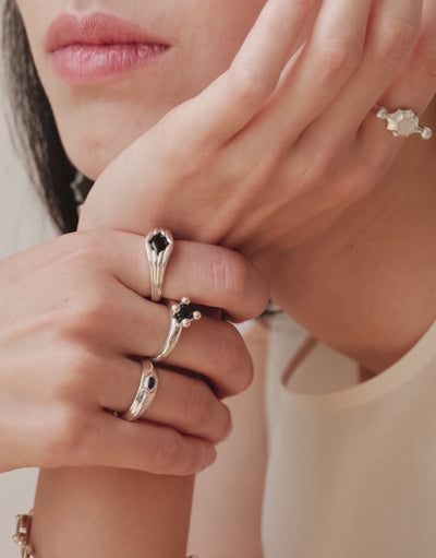 Eyelet Scallop Ring shown in motion, an upcycled glass Eco Gem set in sterling silver. Handmade in Los Angeles. Eyelet Scallop Ring by CLED.