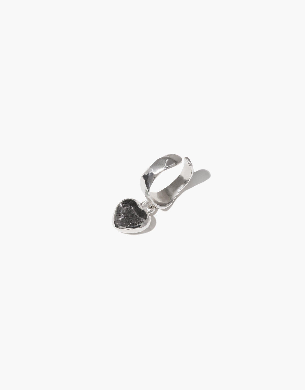 Heart Dangling Ear Cuff featuring a sterling silver ear cuff with a small heart-shaped charm. The charm appears to be made from upcycled eco gem, repurposed from discarded glass bottles. Handcrafted jewelry piece showcasing sustainable design. CLED Heart Dangling Ear Cuff.