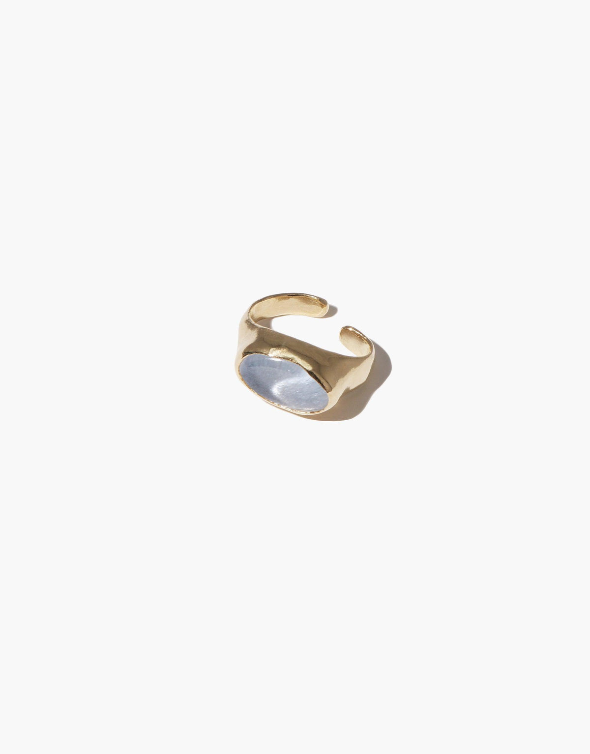 Gold-toned ear cuff with oval sculpture design, featuring a unique shape and smooth finish. Handcrafted jewelry piece for a stylish, modern look. Oval Sculpture Ear Cuff by CLED.