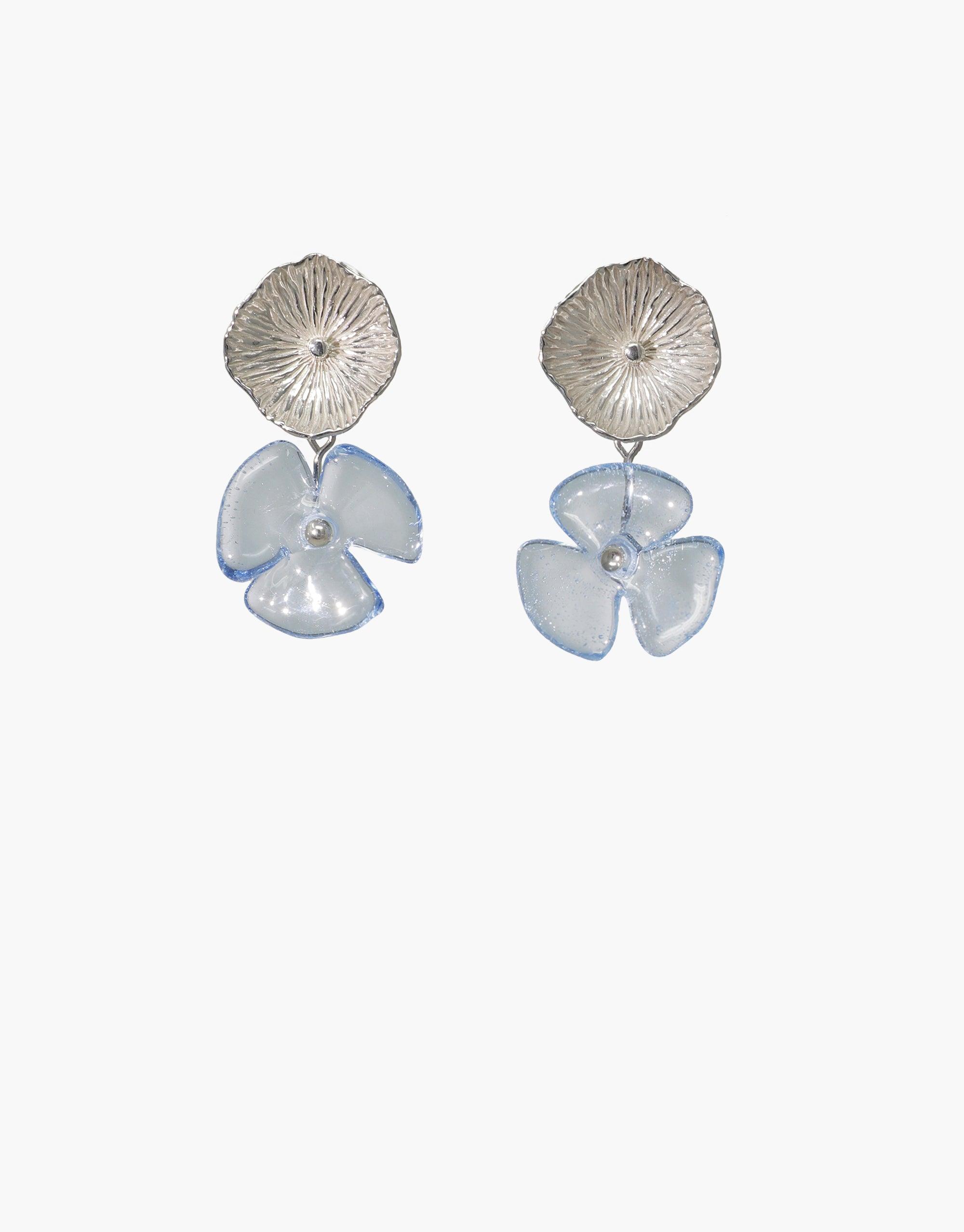 Periwinkle Single Earrings featuring textured silver studs with delicate light blue glass flower drops. Handcrafted eco-friendly jewelry showcasing repurposed glass petals. Elegant and sustainable design for a unique, earthy look. CLED