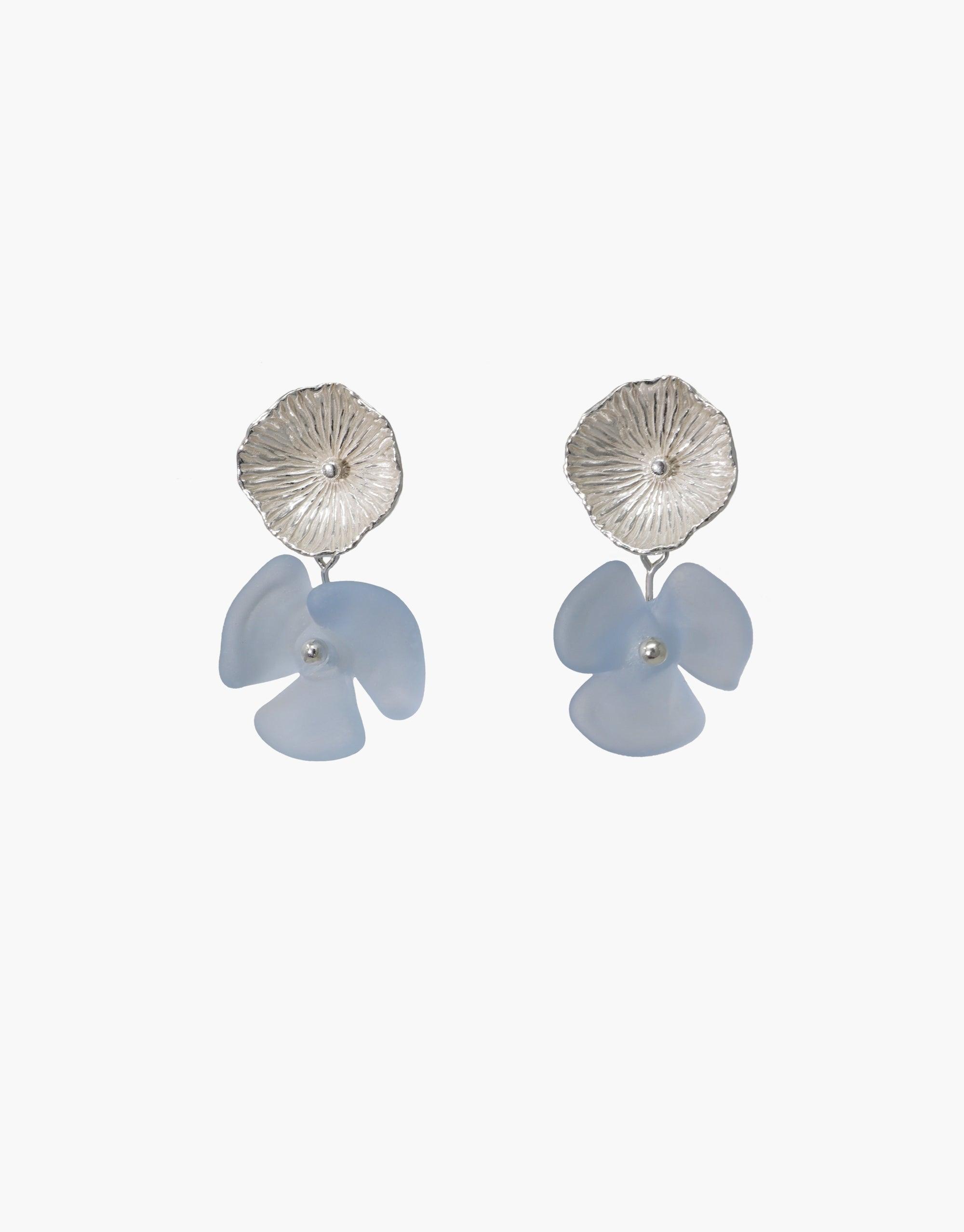 Periwinkle Single Earrings featuring textured silver studs with delicate light blue glass flower drops, handcrafted from eco-friendly repurposed materials. Elegant and sustainable jewelry design by CLED.