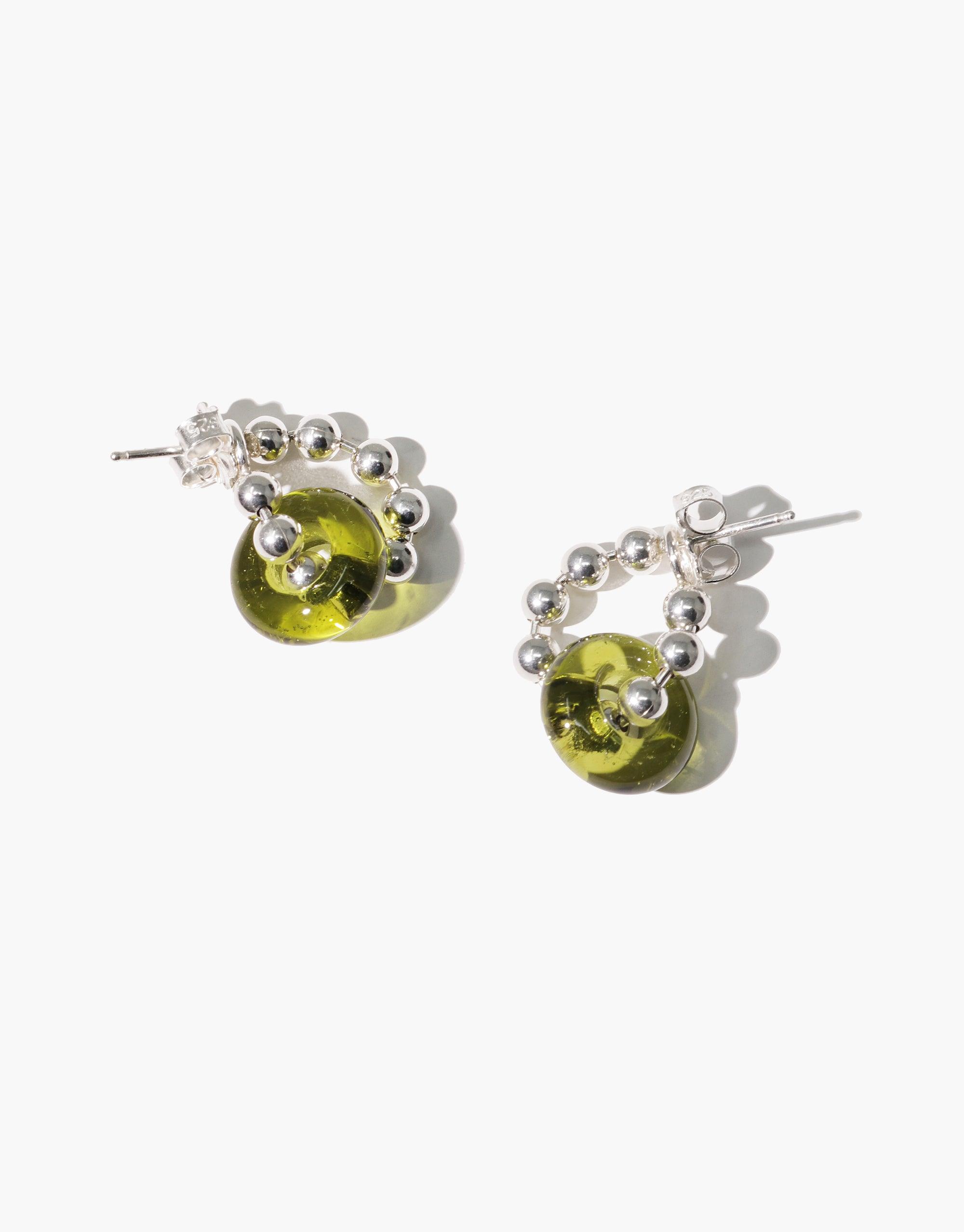 Stylish Donut Ball Hoop Earrings featuring green eco gems made from upcycled glass, surrounded by silver beads. Elegant and sustainable jewelry design showcasing prismatic colors. Handcrafted by CLED.