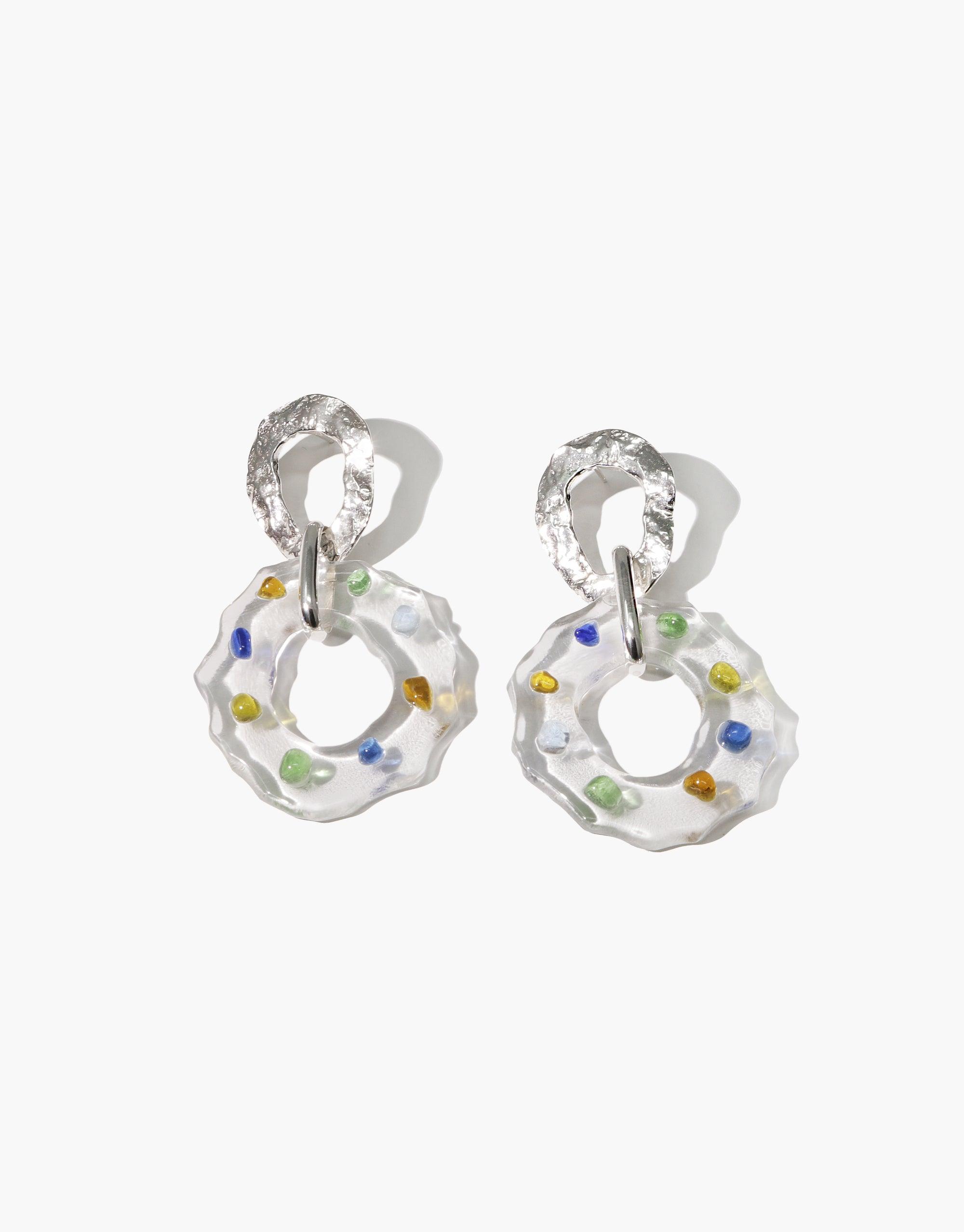 High Tide Earrings in Spectrum featuring translucent glass rings with colorful speckles, attached to textured silver hoops. Handcrafted eco-friendly jewelry showcasing upcycled glass in prismatic colors. Sustainable and stylish dangle earrings by CLED.