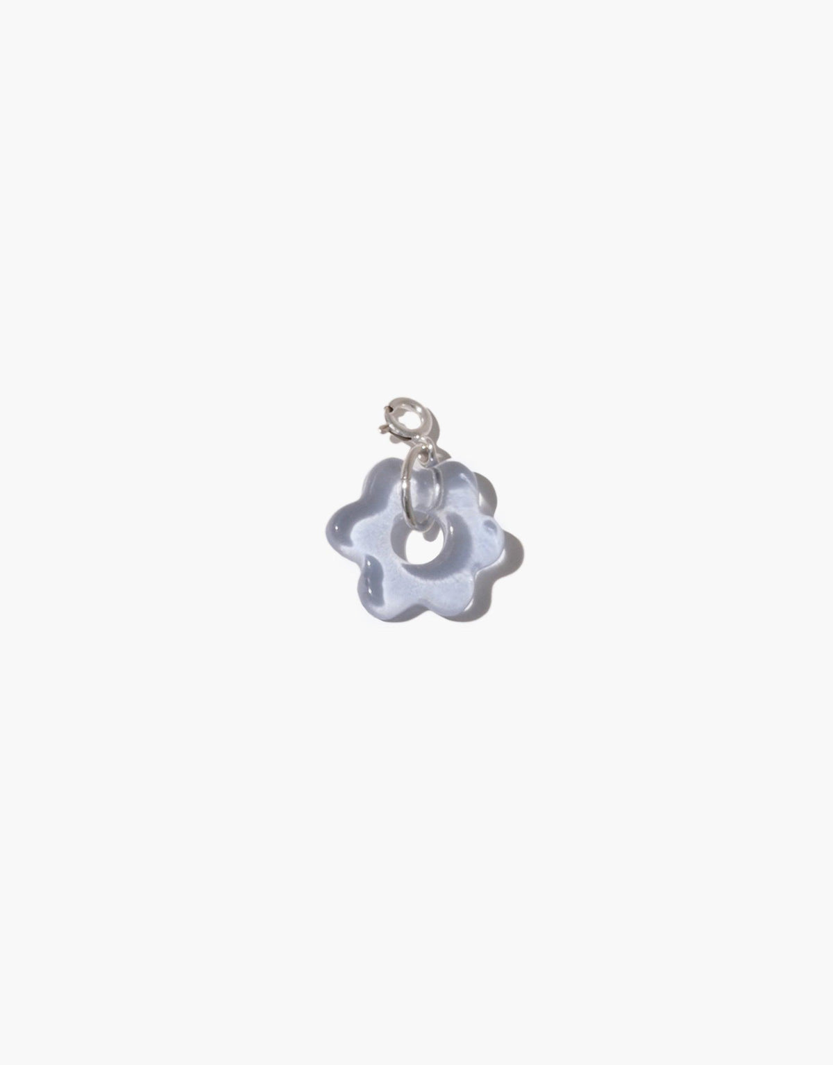 Delicate flower-shaped charm in translucent blue glass with silver attachment, showcasing handcrafted detail. Avens Icon Charm by CLED, perfect for personalizing necklaces or bracelets with eco-friendly elegance.