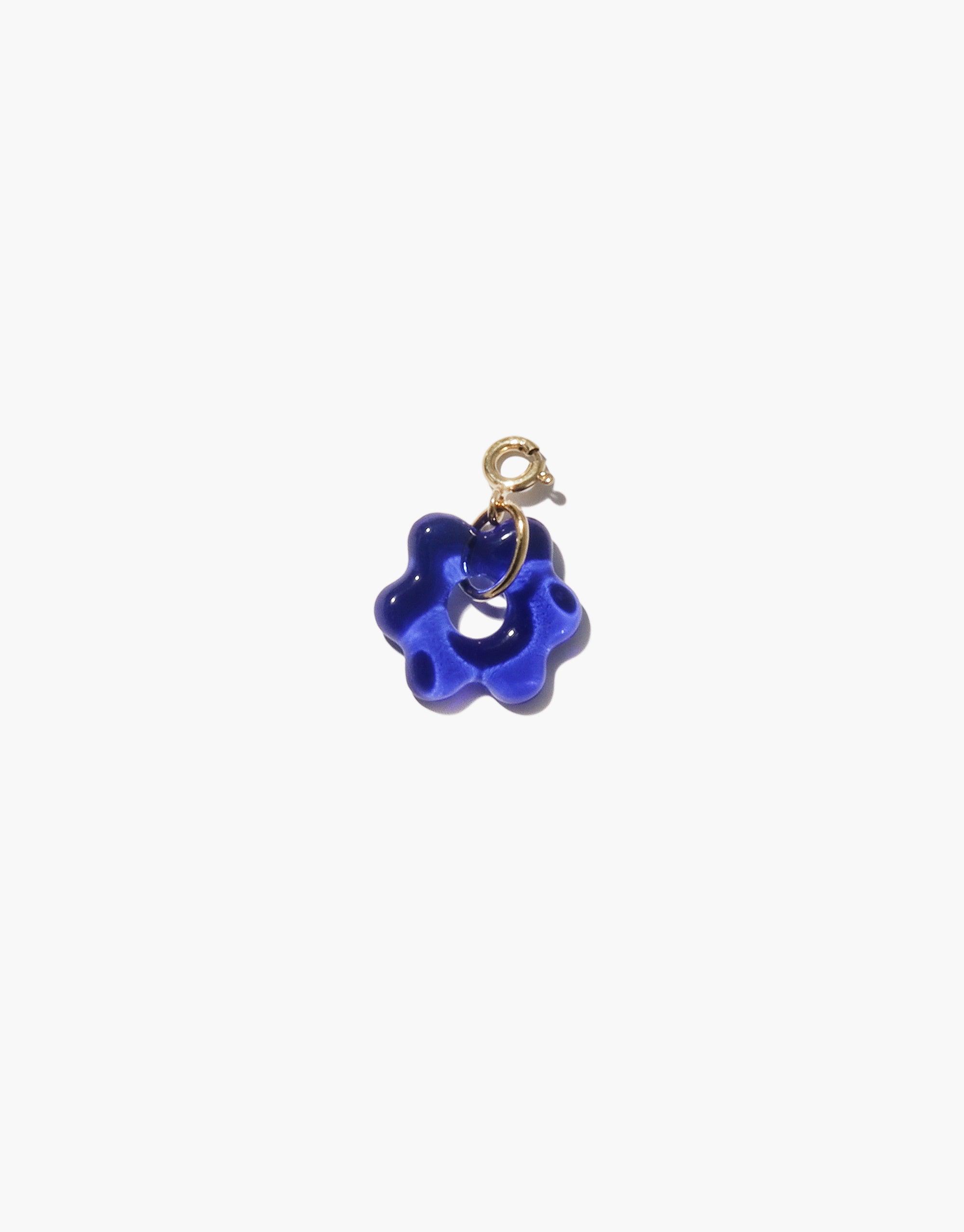 Vibrant blue glass flower charm with gold-tone clasp, part of the Avens Icon Charm collection. Handcrafted from upcycled eco gem, showcasing sustainable jewelry design. Perfect addition to necklaces or bracelets. CLED Avens | Icon Charm.