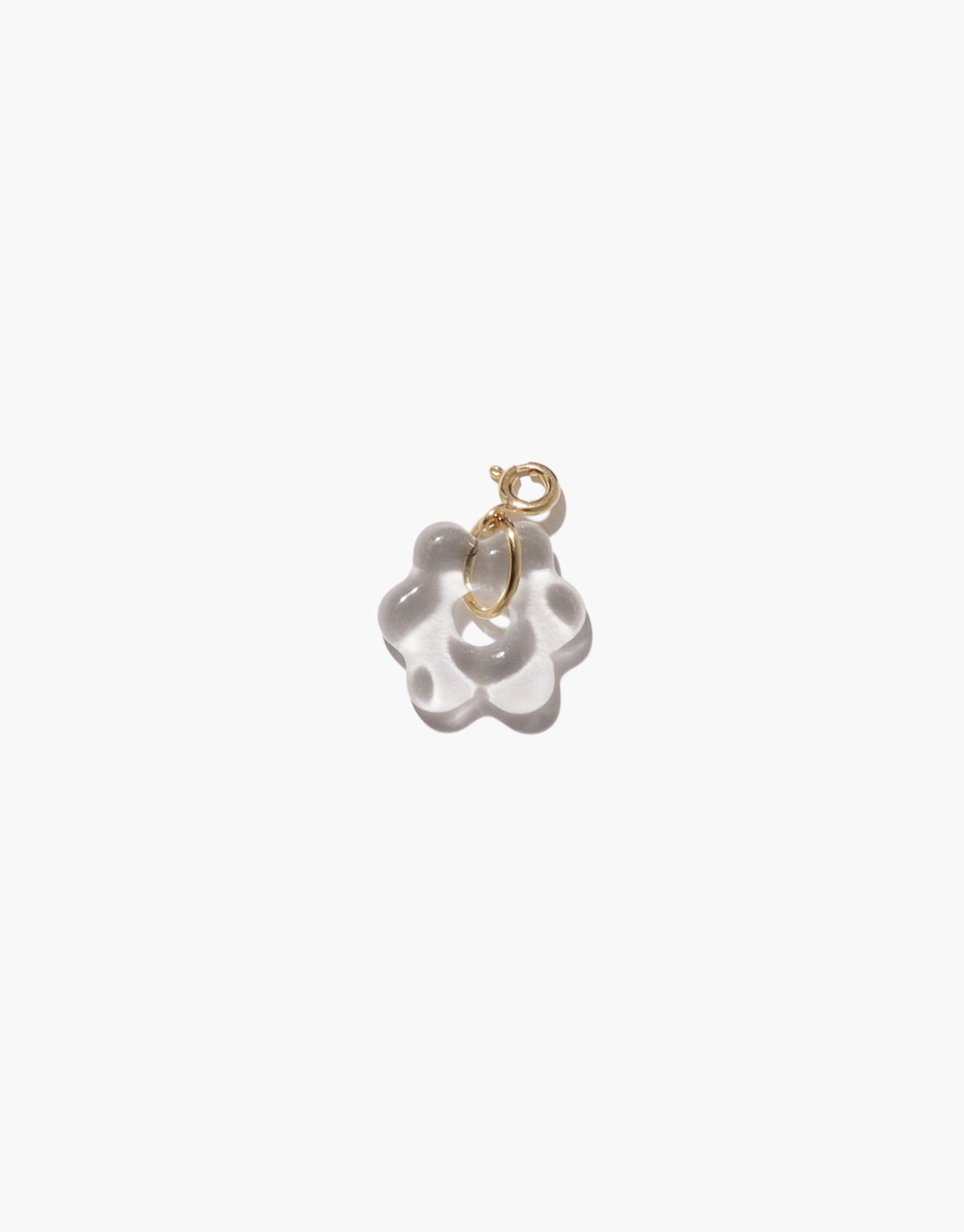 Delicate flower-shaped charm in white upcycled glass with gold vermeil attachment, perfect for necklaces or bracelets. Handmade eco-friendly jewelry piece from the Avens | Icon Charm collection by CLED.