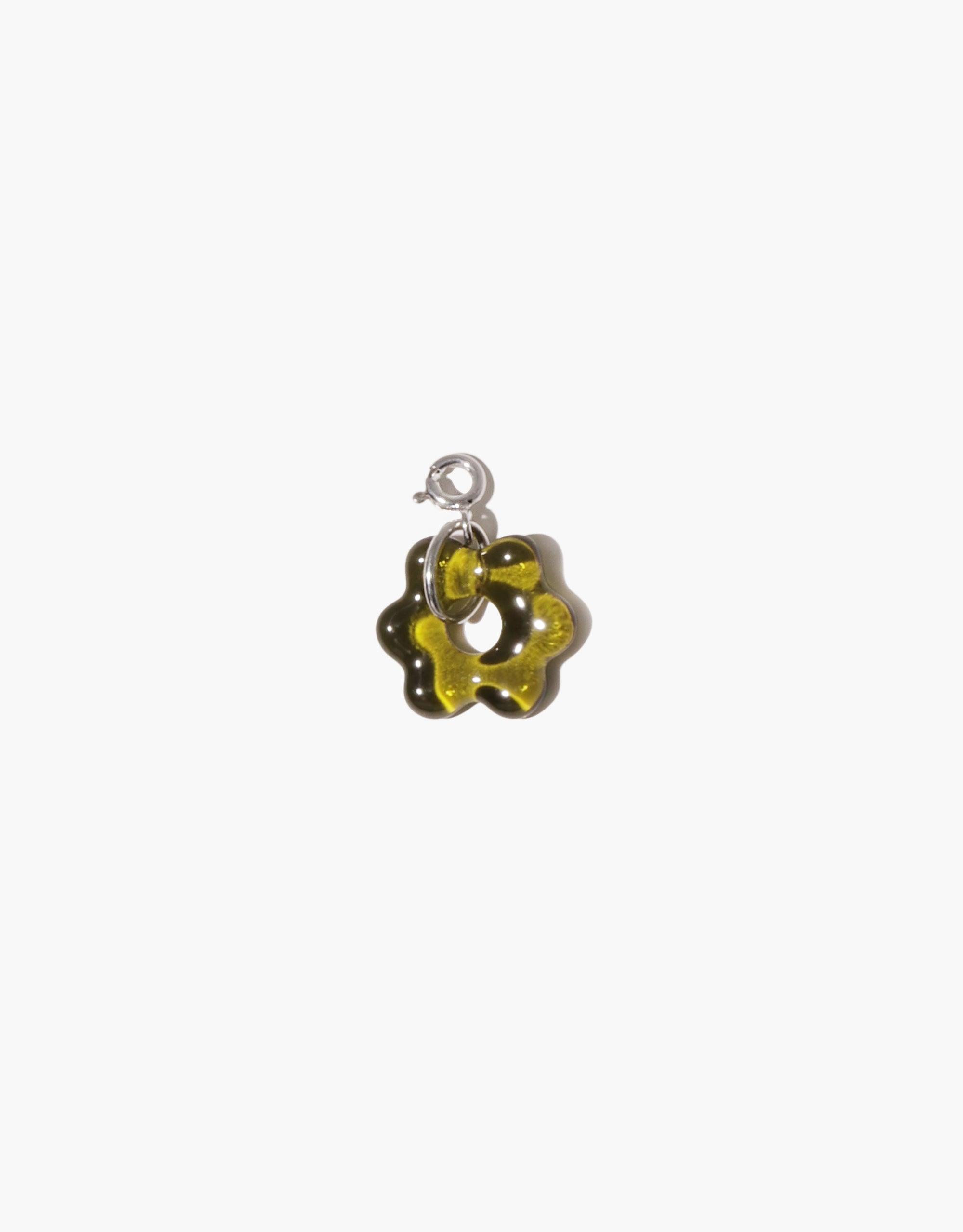 Delicate yellow glass flower charm with silver loop, handcrafted from upcycled eco-friendly materials. Avens Icon Charm for customizable jewelry, perfect for necklaces or bracelets. Sustainable and stylish accessory by CLED.