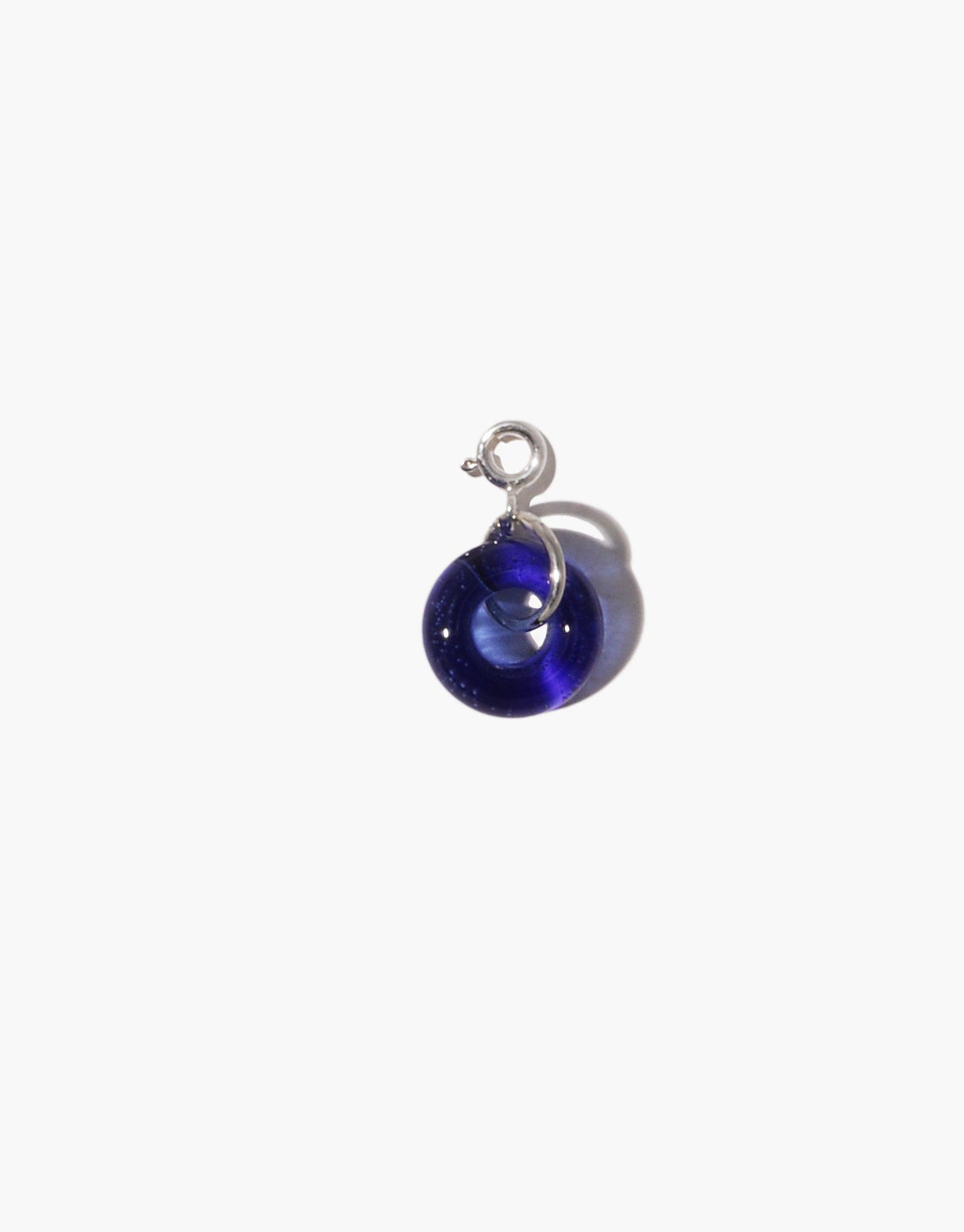 Handcrafted Donut Icon Charm featuring a deep blue upcycled glass sphere with silver hook, perfect for personalizing necklaces or bracelets. Sustainable jewelry piece from CLED's Icon Charm collection.
