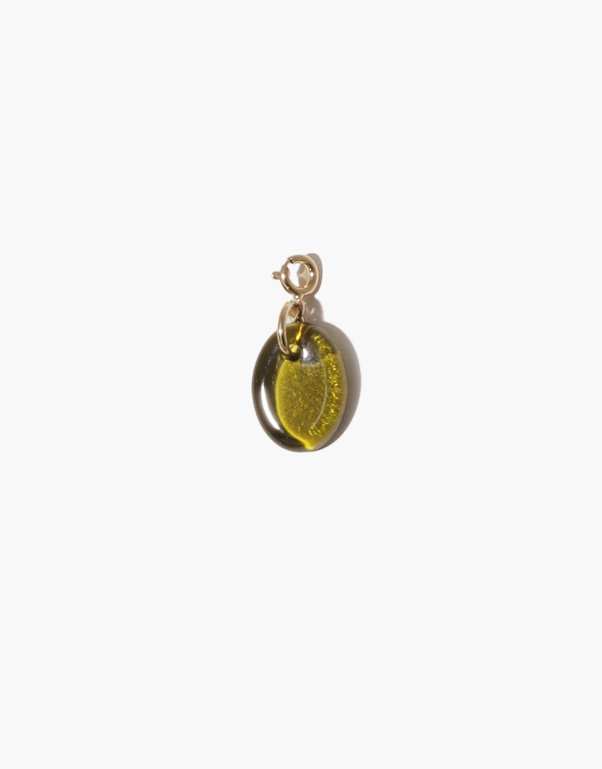Oval Icon Charm featuring a translucent green glass pendant with golden sparkles, attached to a gold-toned metal clasp. Handcrafted jewelry piece showcasing upcycled eco-friendly materials. Versatile accessory for necklaces or bracelets. Oval | Icon Charm by CLED.