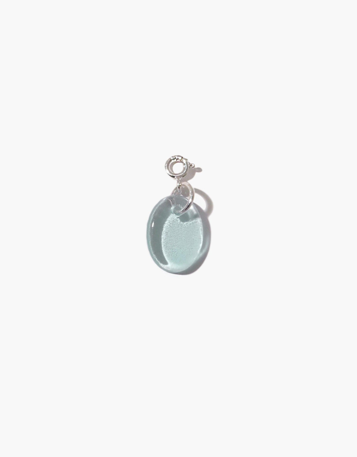 Elegant oval-shaped charm in light blue upcycled glass, attached to a silver clasp. Perfect for adding to necklaces or bracelets. Handcrafted sustainable jewelry piece. Oval | Icon Charm by CLED.