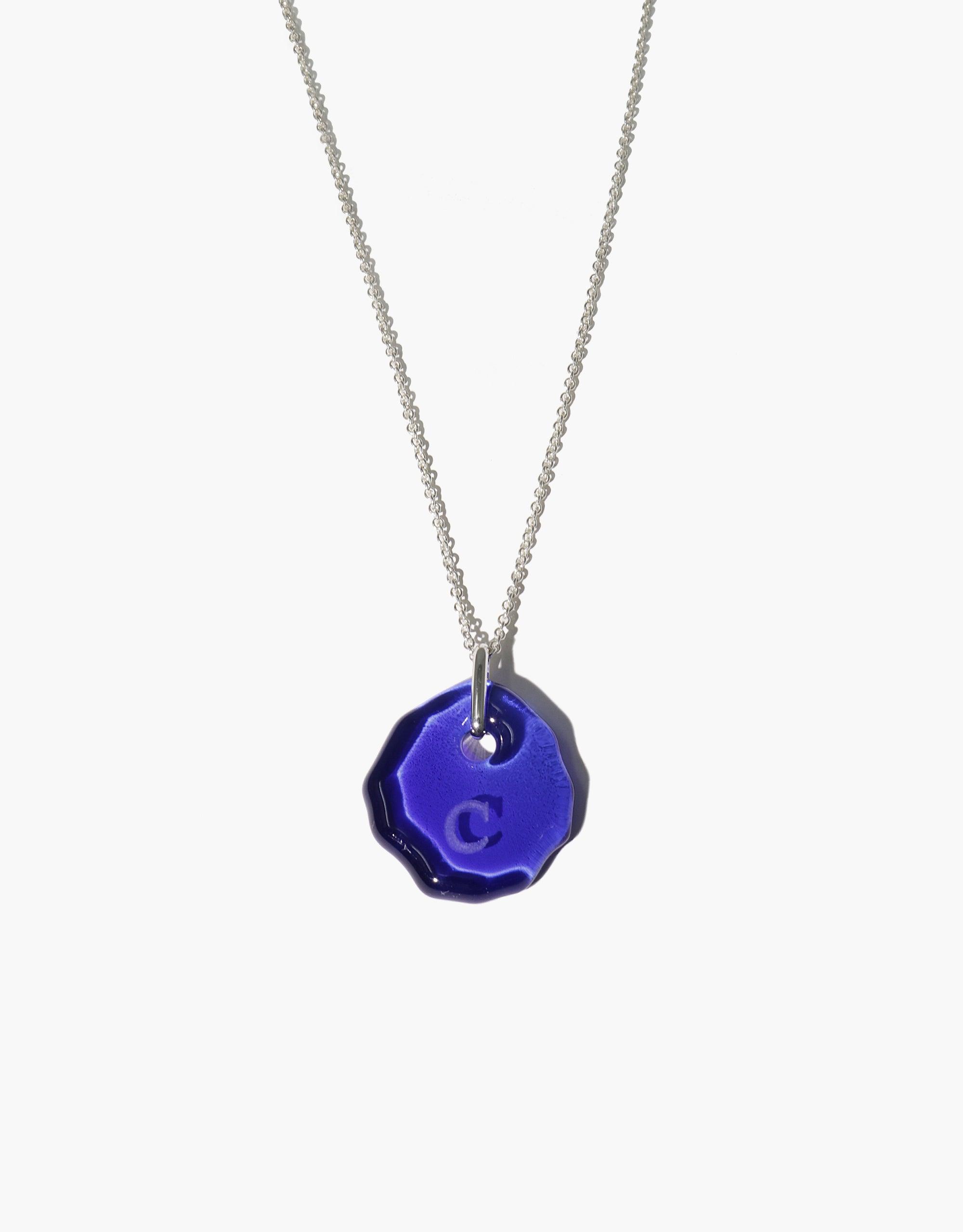 Messenger Necklace with clear engraving on vibrant blue eco gem pendant, suspended from delicate silver chain. Personalized, sustainable jewelry for sharing meaningful messages. Adjustable length, handmade in Los Angeles. CLED Messenger Necklace | Clear Engraving