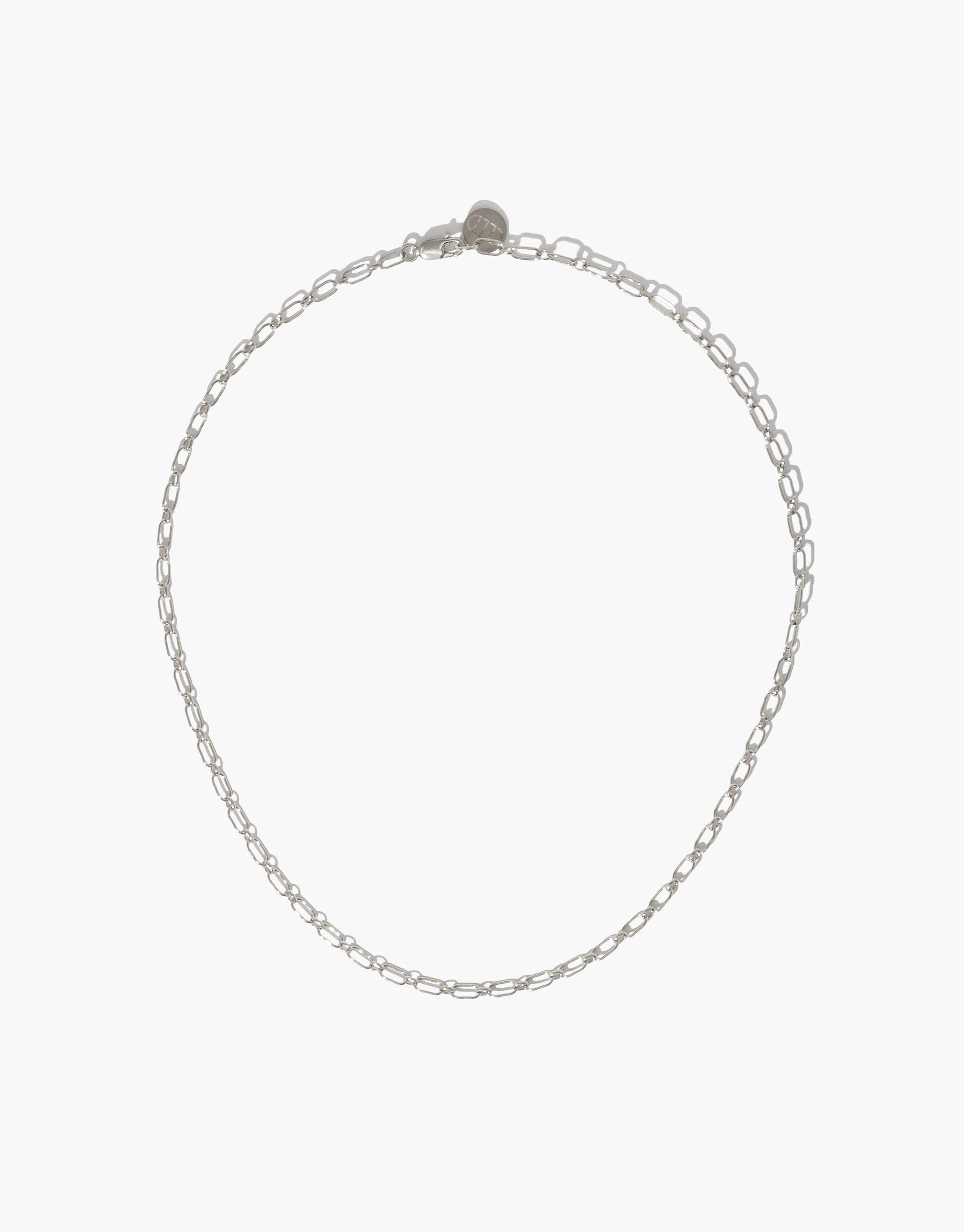 Sleek silver chain necklace with delicate oval links, perfect for layering or wearing alone. Versatile accessory for creating a personalized look with optional charms. Icon Chain Necklace | B by CLED