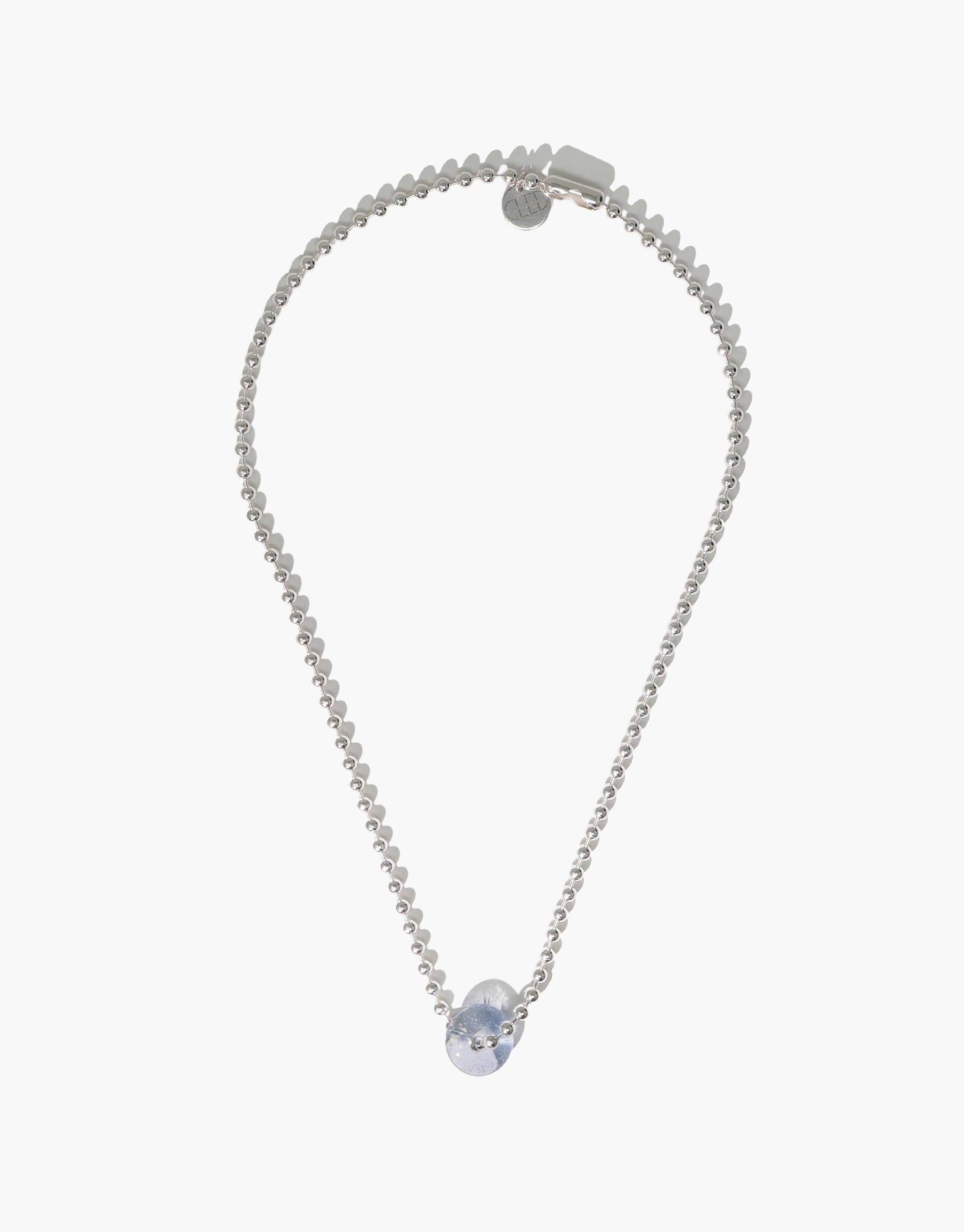 Elegant silver necklace featuring a delicate chain and a single iridescent eco-gem pendant, showcasing sustainable luxury. Donut Ball Necklace by CLED, crafted from upcycled glass for eco-conscious fashion lovers.