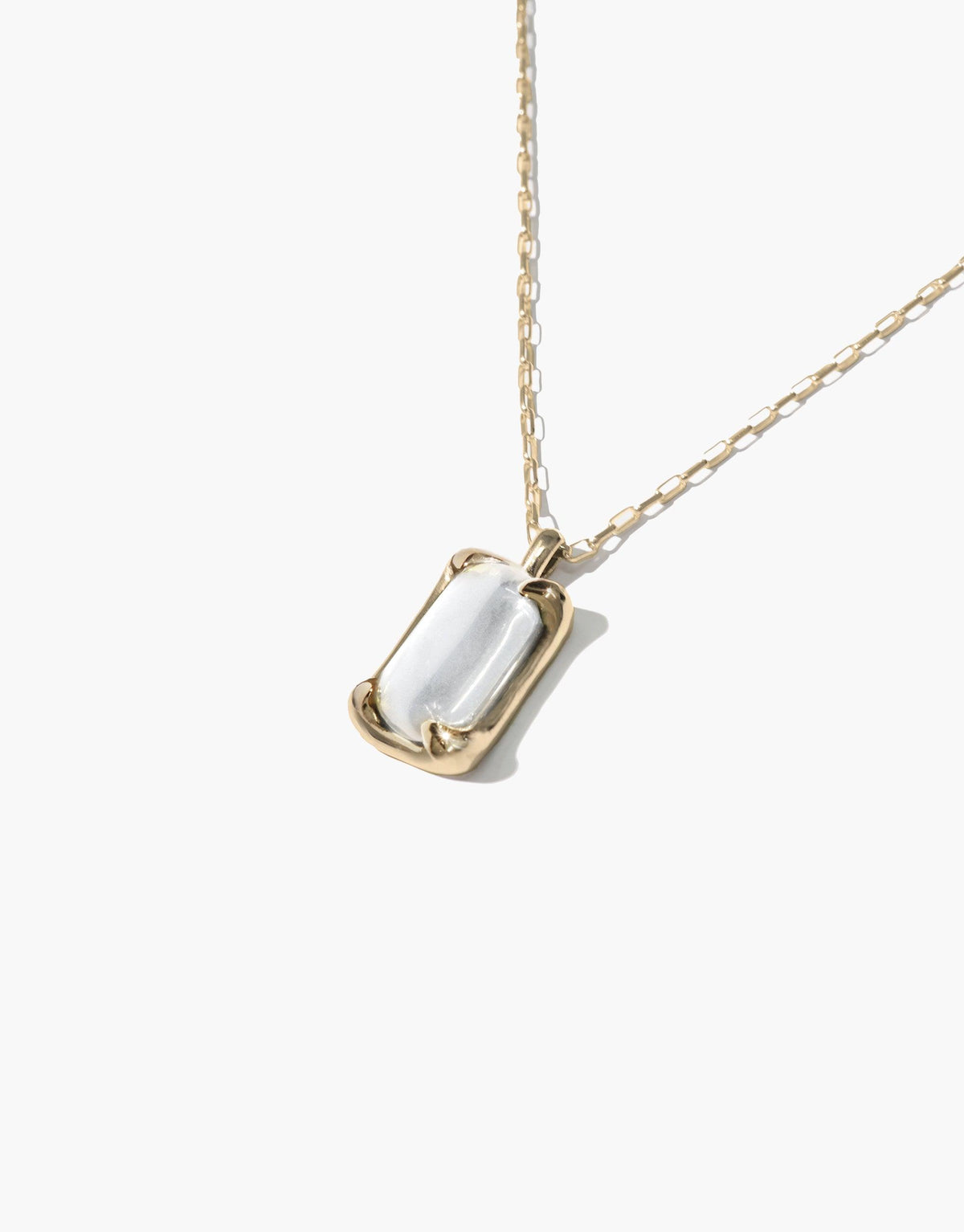 Elegant Prism Necklace featuring a rectangular eco gem pendant in gold-toned setting, suspended on a delicate chain. Handcrafted from upcycled glass, this sustainable jewelry piece captures light beautifully. Prism Necklace by CLED.