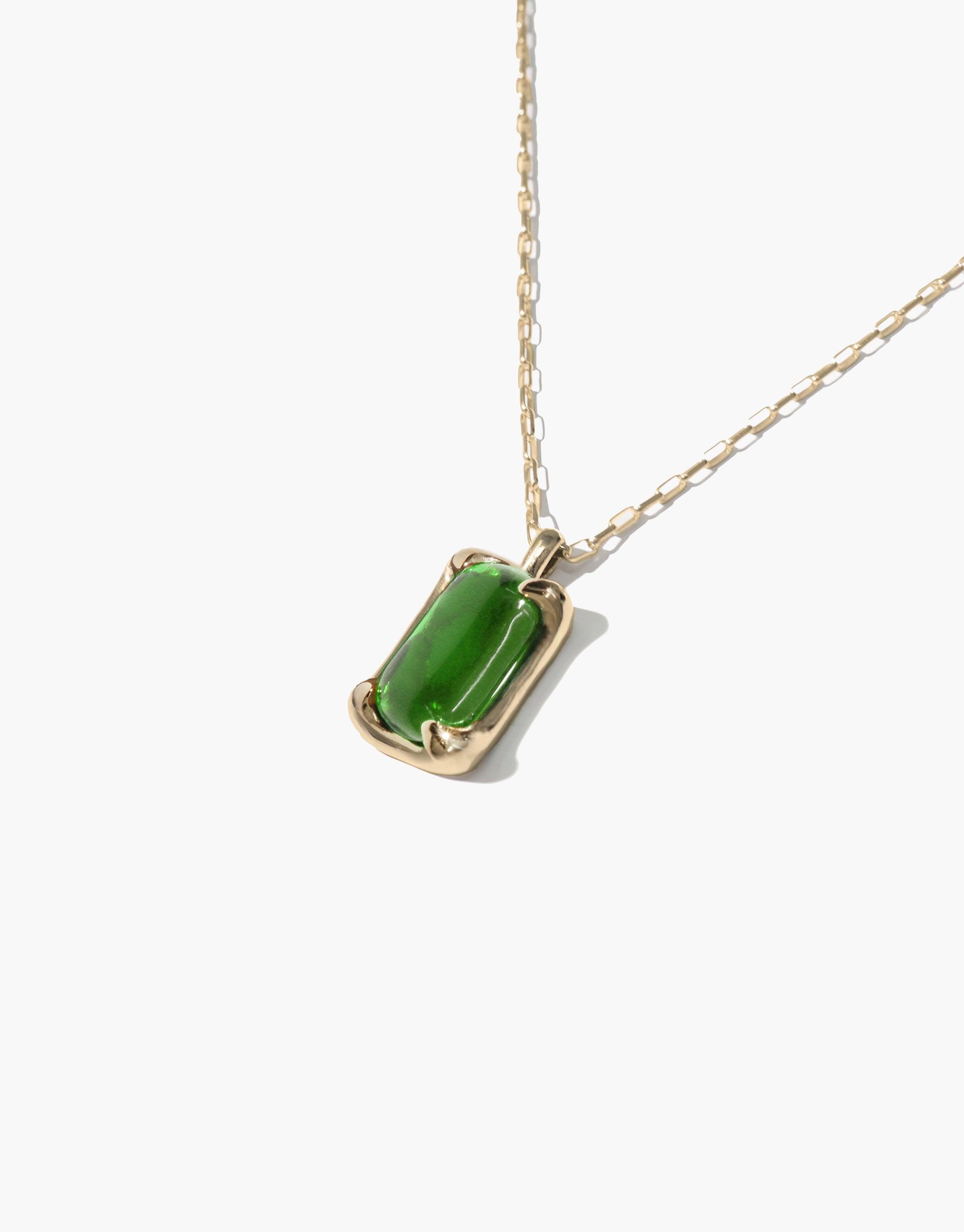 Prism Necklace featuring a rectangular green eco gem pendant on a delicate gold chain. Handcrafted jewelry showcasing upcycled glass in a minimalist design. Elegant and sustainable accessory that captures light and color. CLED