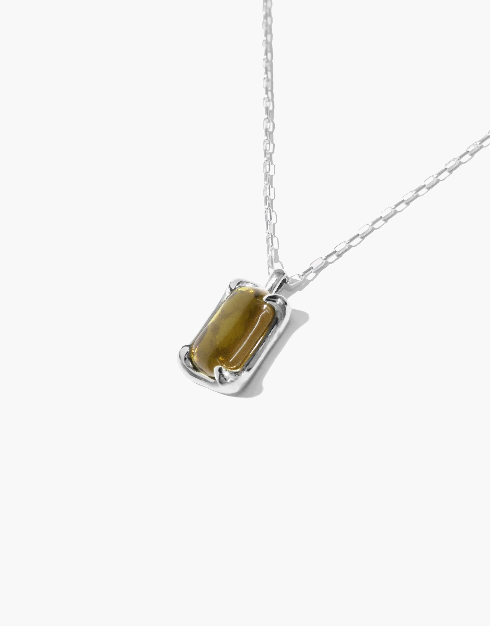 Elegant Prism Necklace featuring a rectangular olive-green eco gem pendant on a delicate silver chain. Handcrafted sustainable jewelry showcasing upcycled glass in a minimalist design. Perfect for eco-conscious fashion lovers. CLED Prism Necklace.