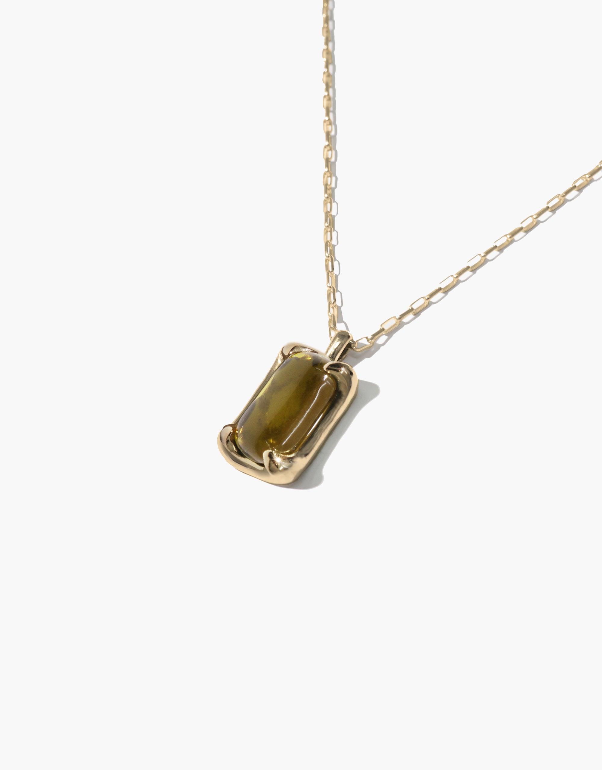 Prism Necklace featuring a delicate gold chain and rectangular pendant with olive-green eco gem made from upcycled glass. Elegant and sustainable jewelry design showcasing CLED's commitment to eco-friendly fashion. Handcrafted Prism Necklace by CLED.