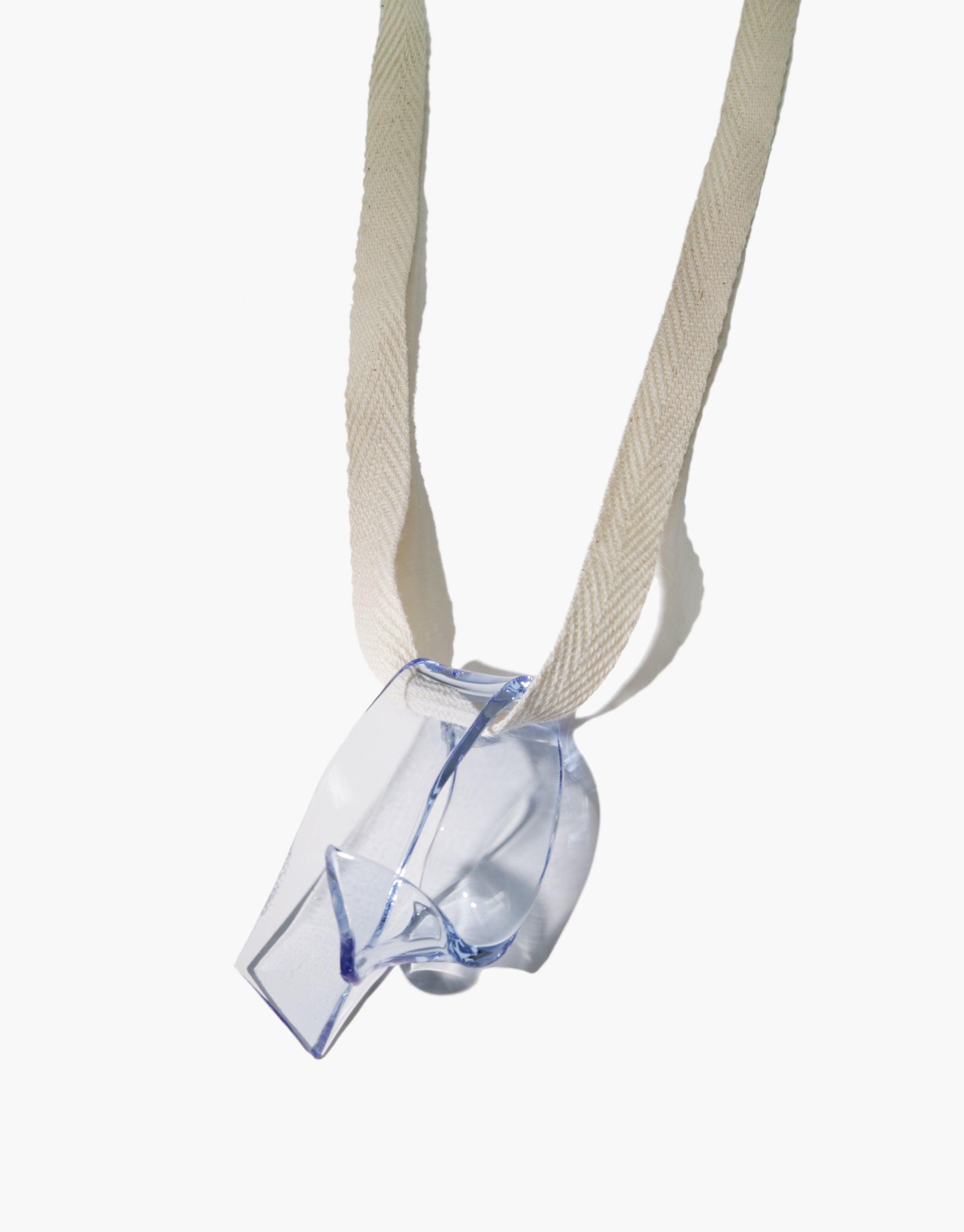 Handcrafted Ribbon Necklace featuring eco-friendly glass pendant in serpentine shape, suspended on cotton ribbon. Sustainable accessory showcasing repurposed glass in matte or shiny finish. Unique, eco-conscious design by CLED. Ribbon Necklace.