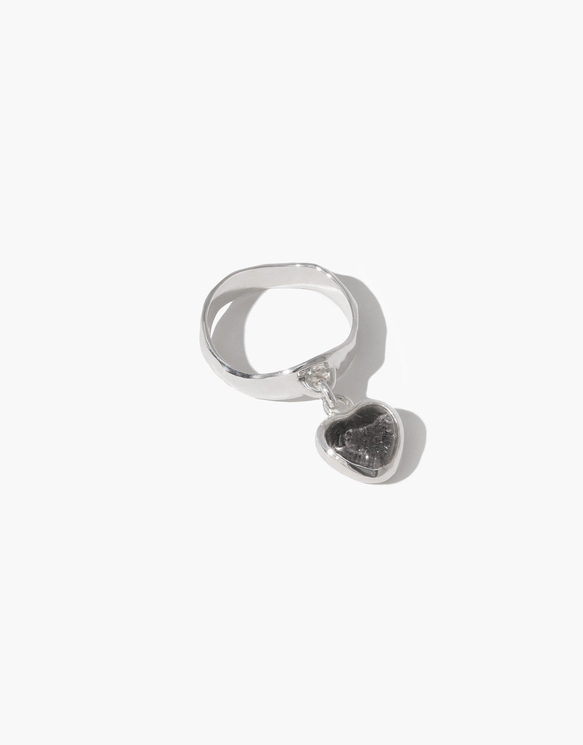 Sterling silver Heart Dangling Ring featuring a unique eco-friendly charm made from upcycled glass. Handcrafted design with a playful heart-shaped pendant suspended from a sleek band. Sustainable and stylish jewelry piece by CLED.