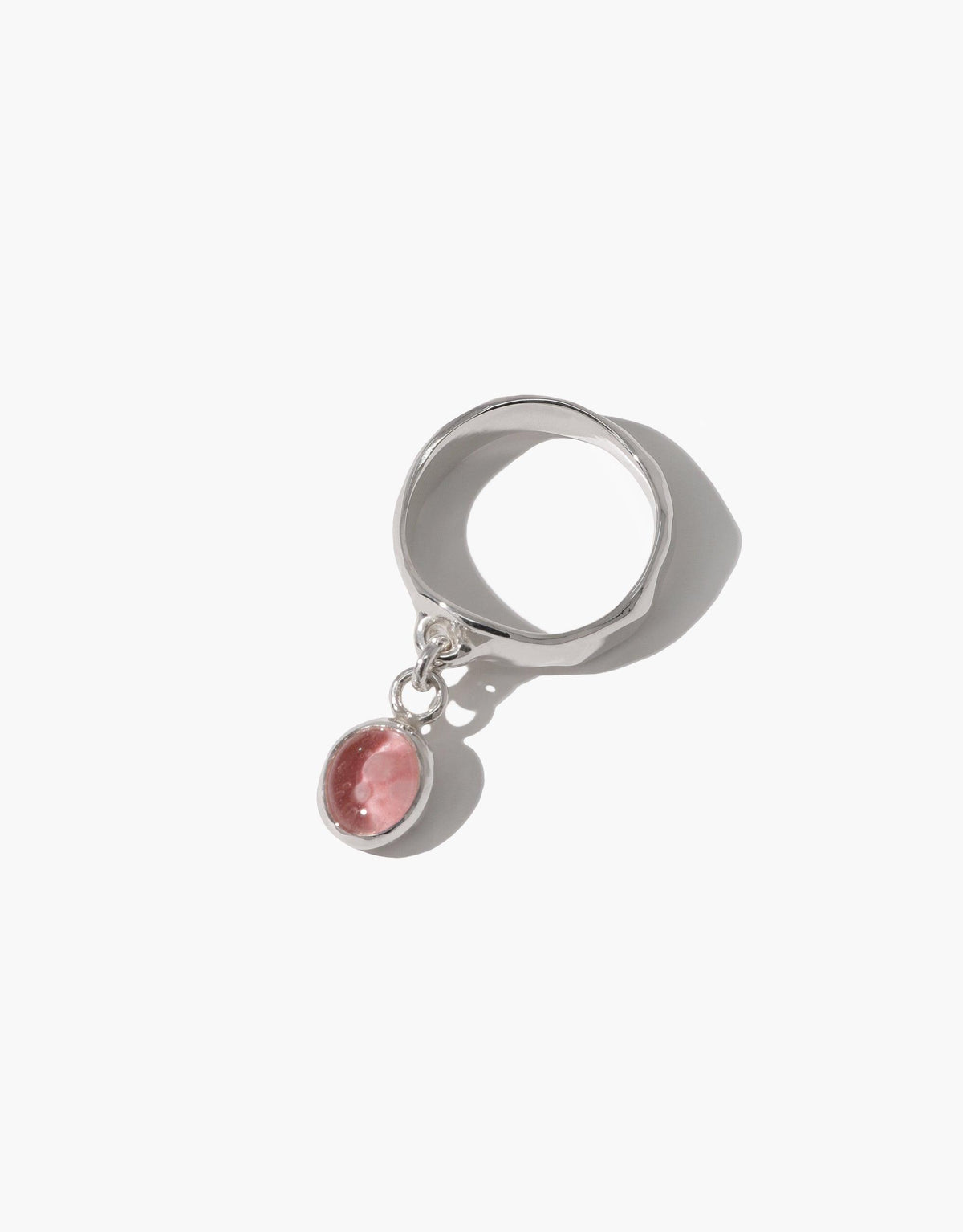 Oval Dangling Ring featuring a silver band with a pink eco-friendly glass charm suspended from it. Handcrafted jewelry piece showcasing sustainable design and upcycled materials. Elegant and environmentally conscious accessory by CLED.