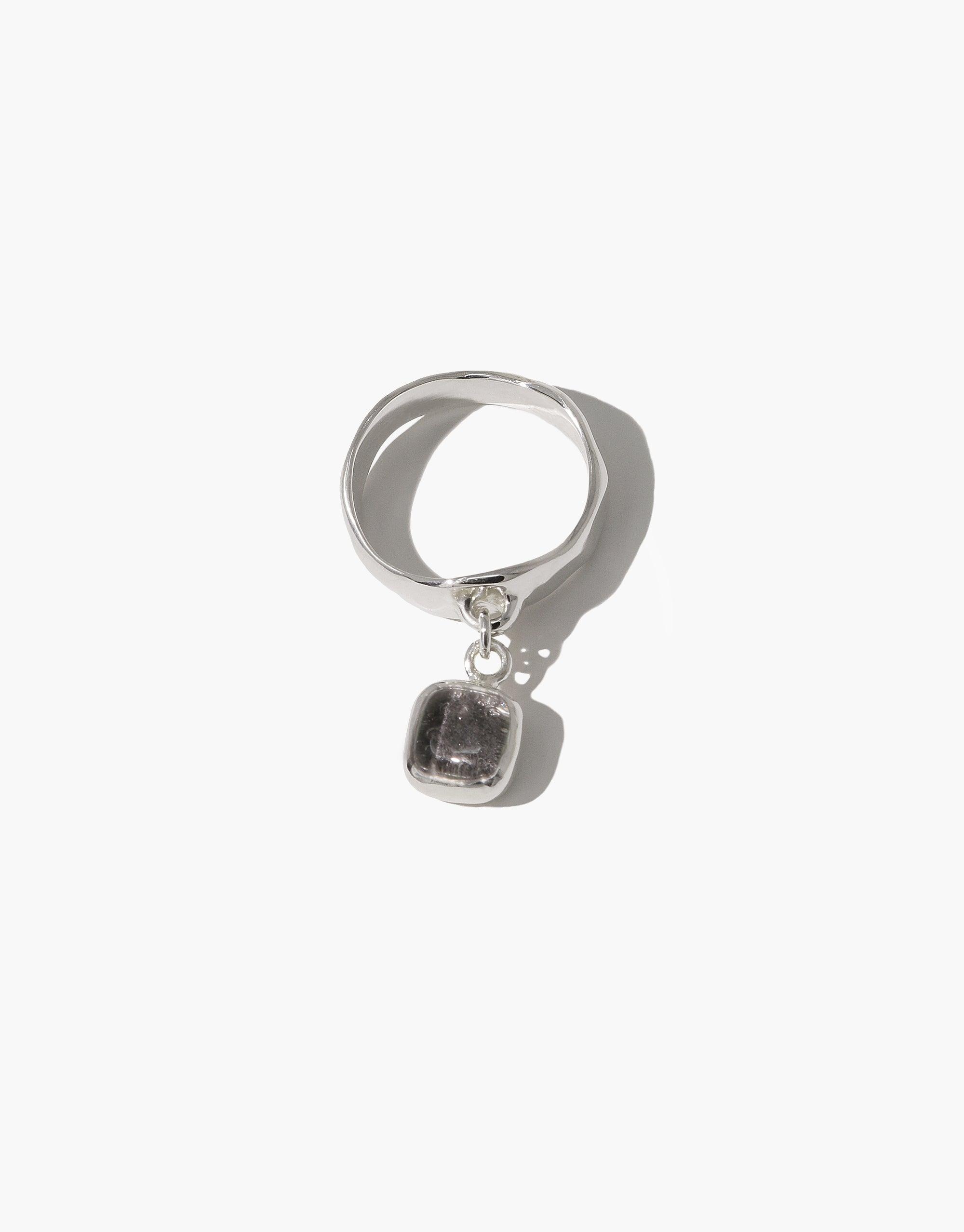 Square Dangling Ring featuring a silver band with a square Eco Gem pendant, handcrafted from upcycled glass, reflecting CLED's eco-conscious design ethos.
