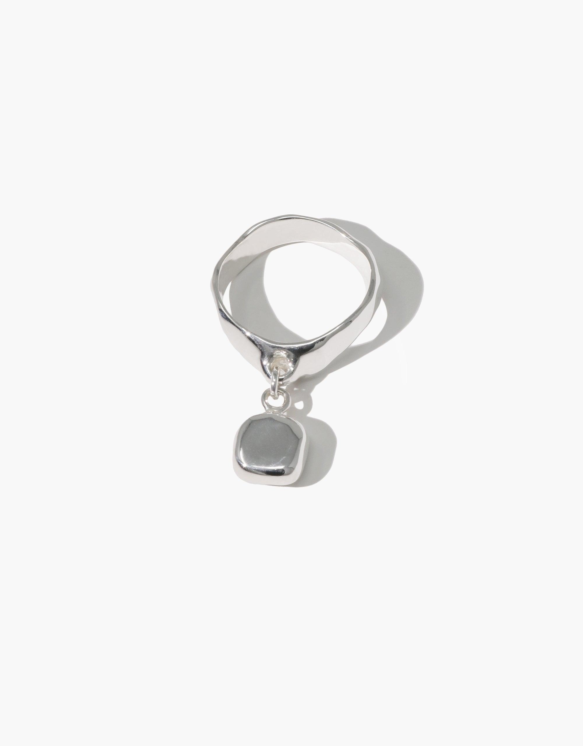 Square Dangling Ring featuring a silver band and a square pendant, showcasing a repurposed Eco Gem. A handmade piece reflecting CLED's eco-conscious jewelry ethos.