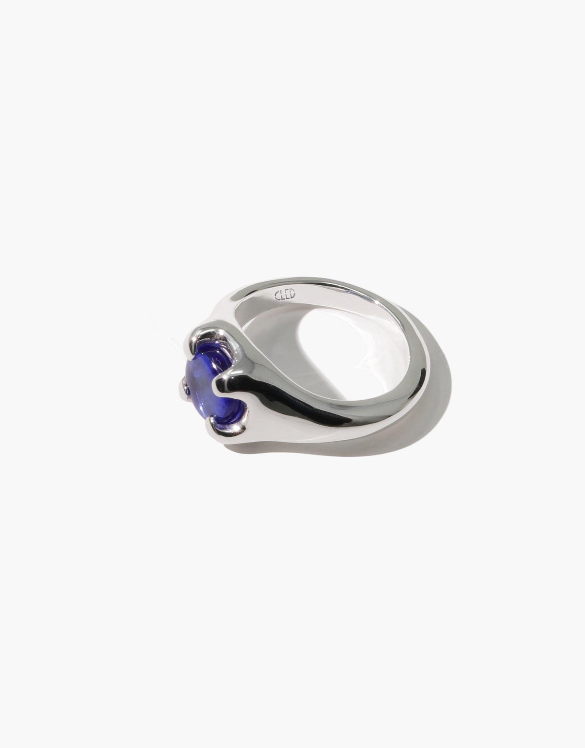 Beam Ring featuring a sleek silver band with a vibrant blue eco gem, handcrafted from upcycled glass. Elegant and sustainable jewelry design showcasing prism-inspired colors. CLED