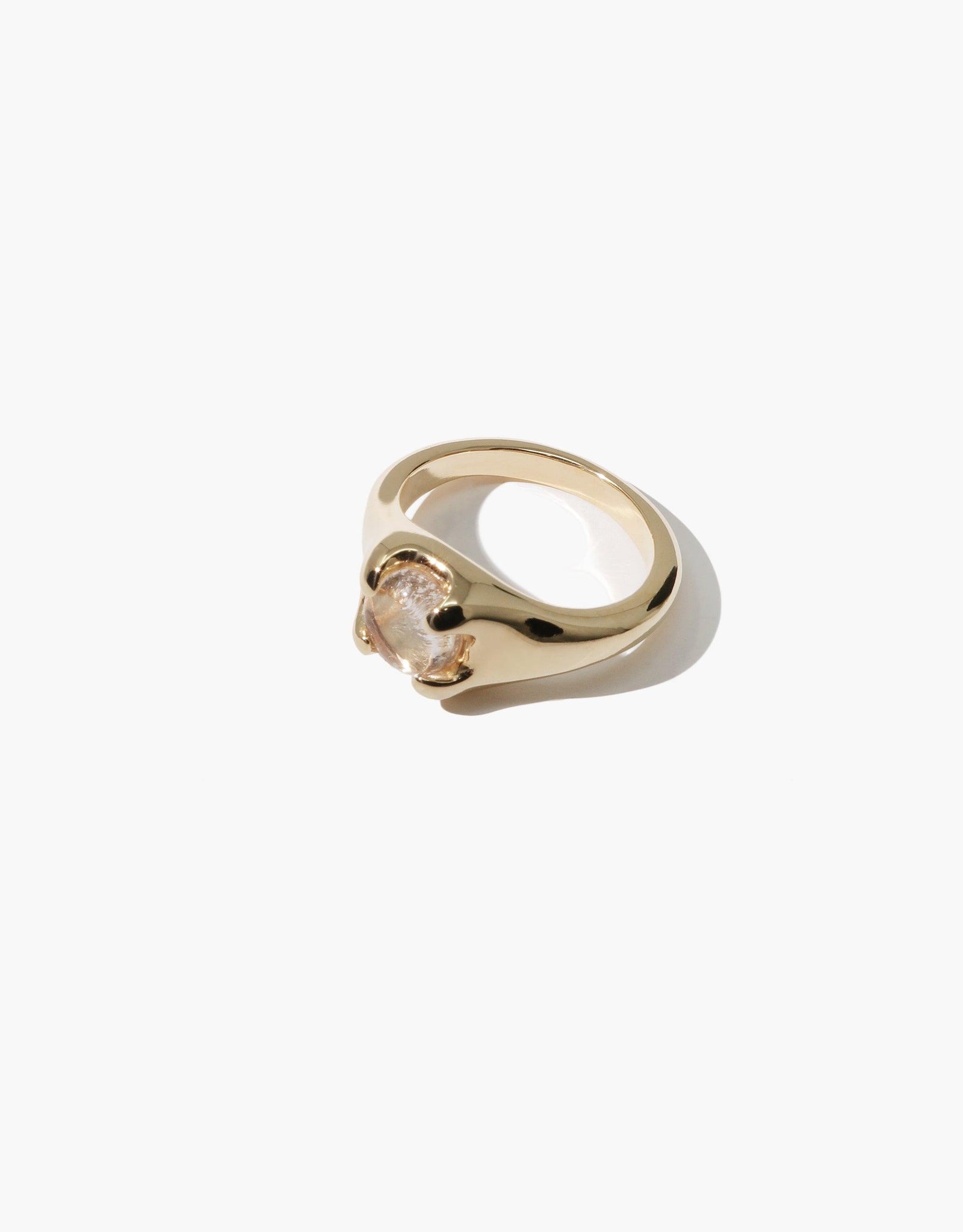 Gold-toned Beam Ring featuring a unique curved design with a light pink eco gem centerpiece, showcasing sustainable luxury and handcrafted elegance. CLED