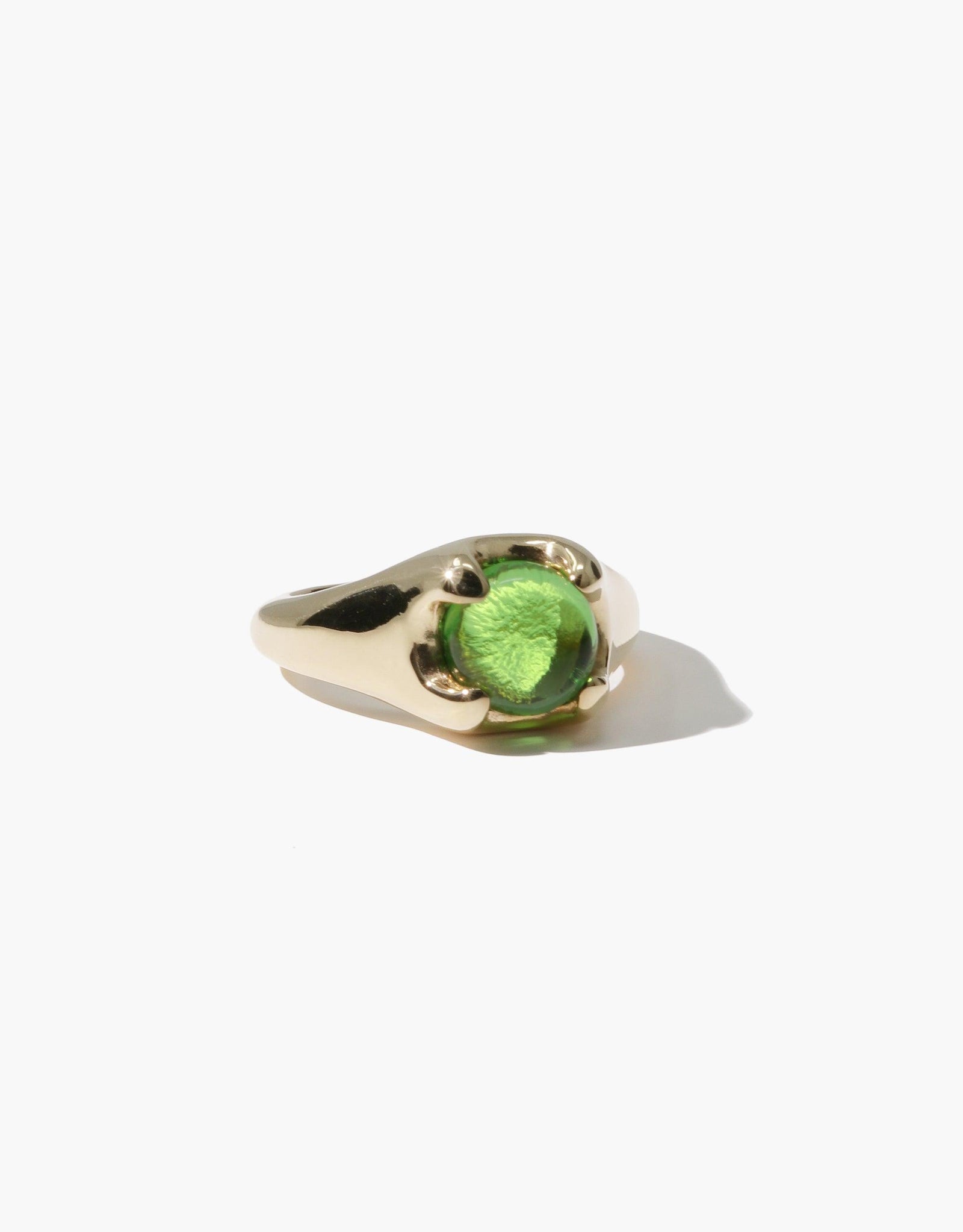 Beam Ring featuring a vibrant green eco gem set in a sleek gold-toned metal band, showcasing sustainable luxury and prismatic beauty. Handcrafted jewelry piece by CLED.
