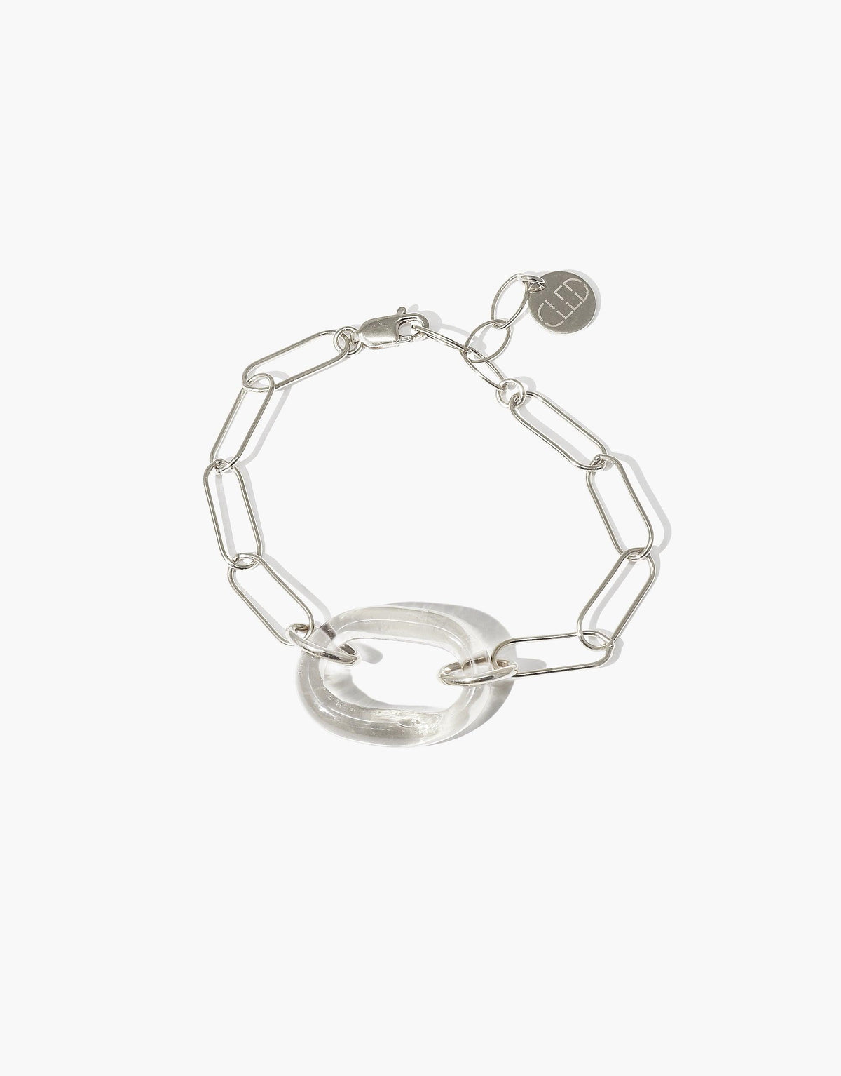 The Day Loop Bracelet features a silver oval chain with a clear Eco Gem ring, showcasing CLED's eco-conscious design and craftsmanship, handmade in Los Angeles from repurposed glass.