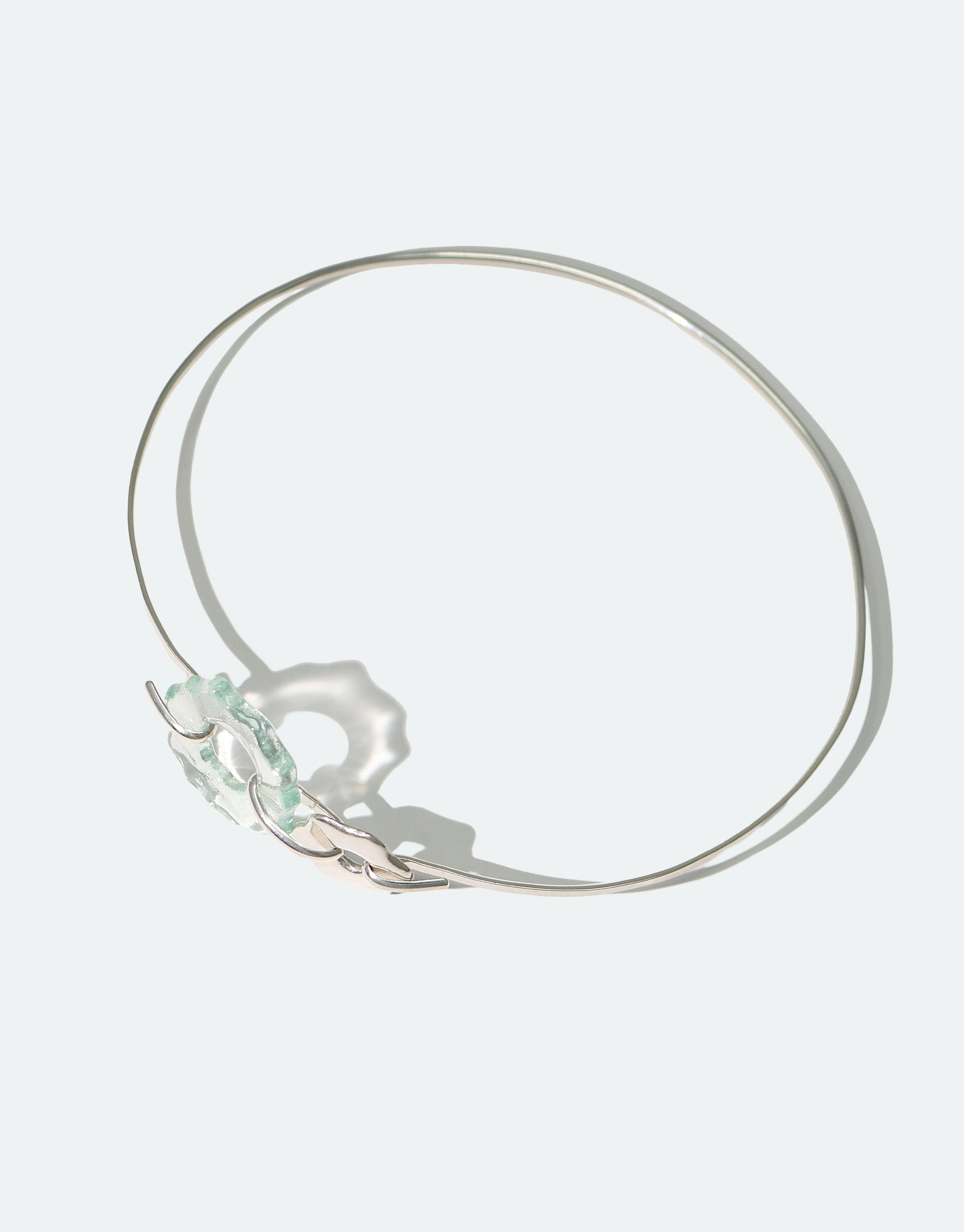 Elegant Avens Choker Necklace featuring delicate silver wire and translucent glass petal drops, inspired by Arctic flora. Minimalist design suitable for day to evening wear. Eco-friendly jewelry made from repurposed glass bottles. Handcrafted piece by CLED.