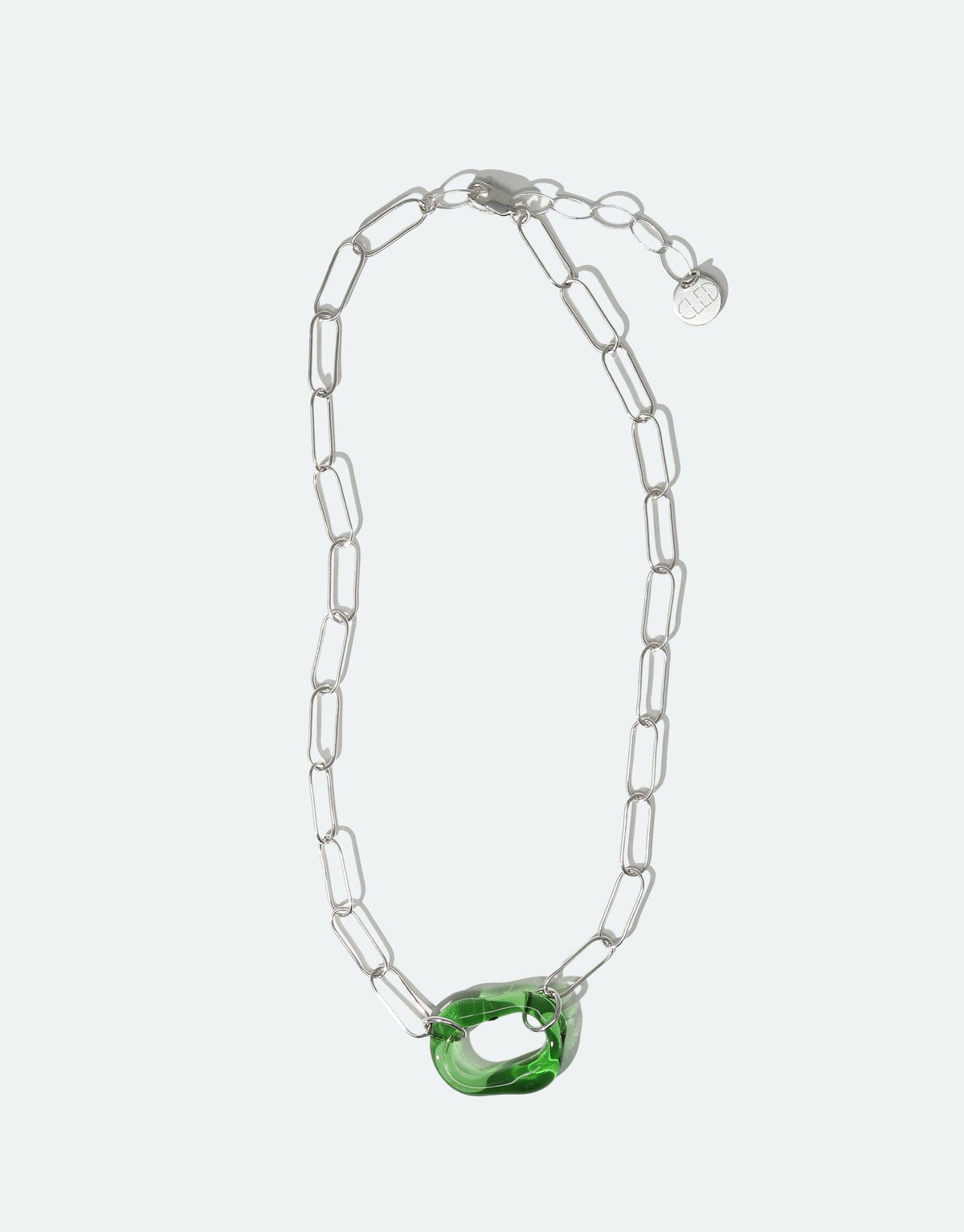 The Day Loop Necklace, featuring a green eco gem bead on a silver paperclip chain, embodies sustainable elegance. Crafted from repurposed glass, this handmade piece reflects CLED's eco-conscious ethos.