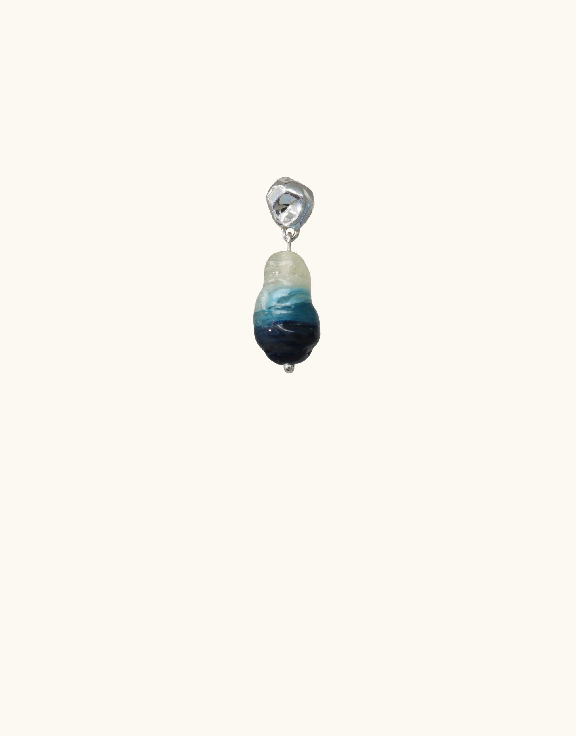 Handcrafted Shades of Nature Waterfall Earring featuring a teardrop-shaped eco-gem in blue and white hues, inspired by canyon terrain and waterfalls. Sterling silver setting. Sustainable jewelry from the Terrain Collection by CLED.