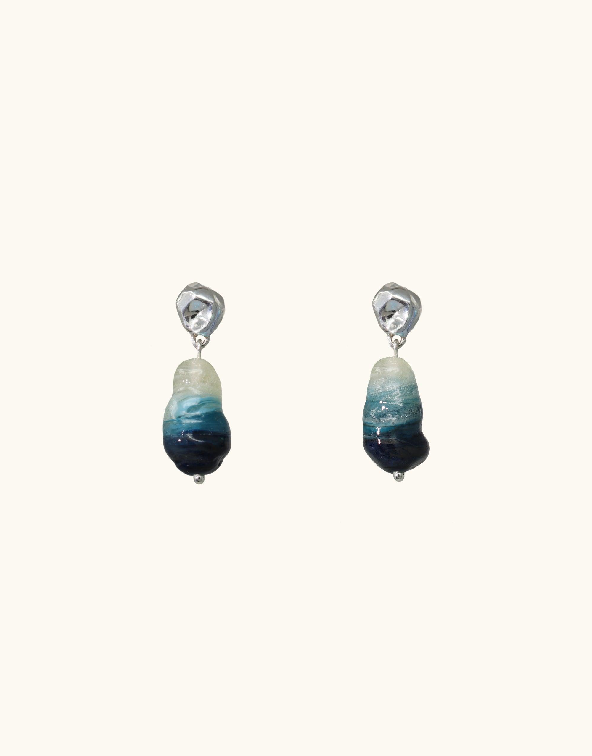 Elegant Shades of Nature Waterfall Earrings featuring blue ombre eco-glass pendants. Handcrafted sterling silver drops inspired by canyon terrain. Sustainable jewelry showcasing repurposed bottle glass. Unique, eco-friendly accessories by CLED.