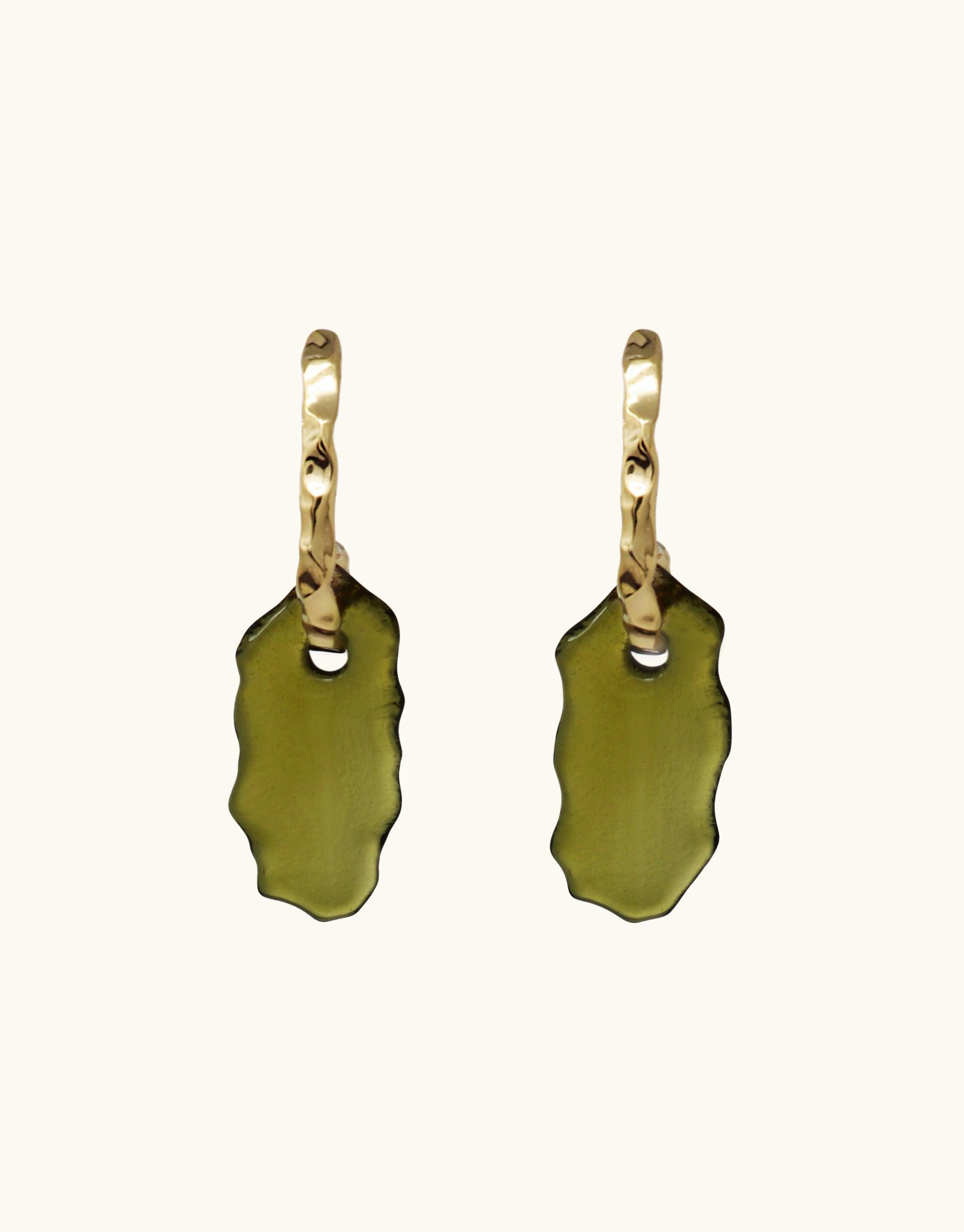 Gold hoop earrings with olive green glass pendants, inspired by canyon terrain. Handcrafted curved design with irregular-shaped drops, showcasing eco-friendly repurposed glass. Elegant and statement-making Rock Spire Earrings by CLED.