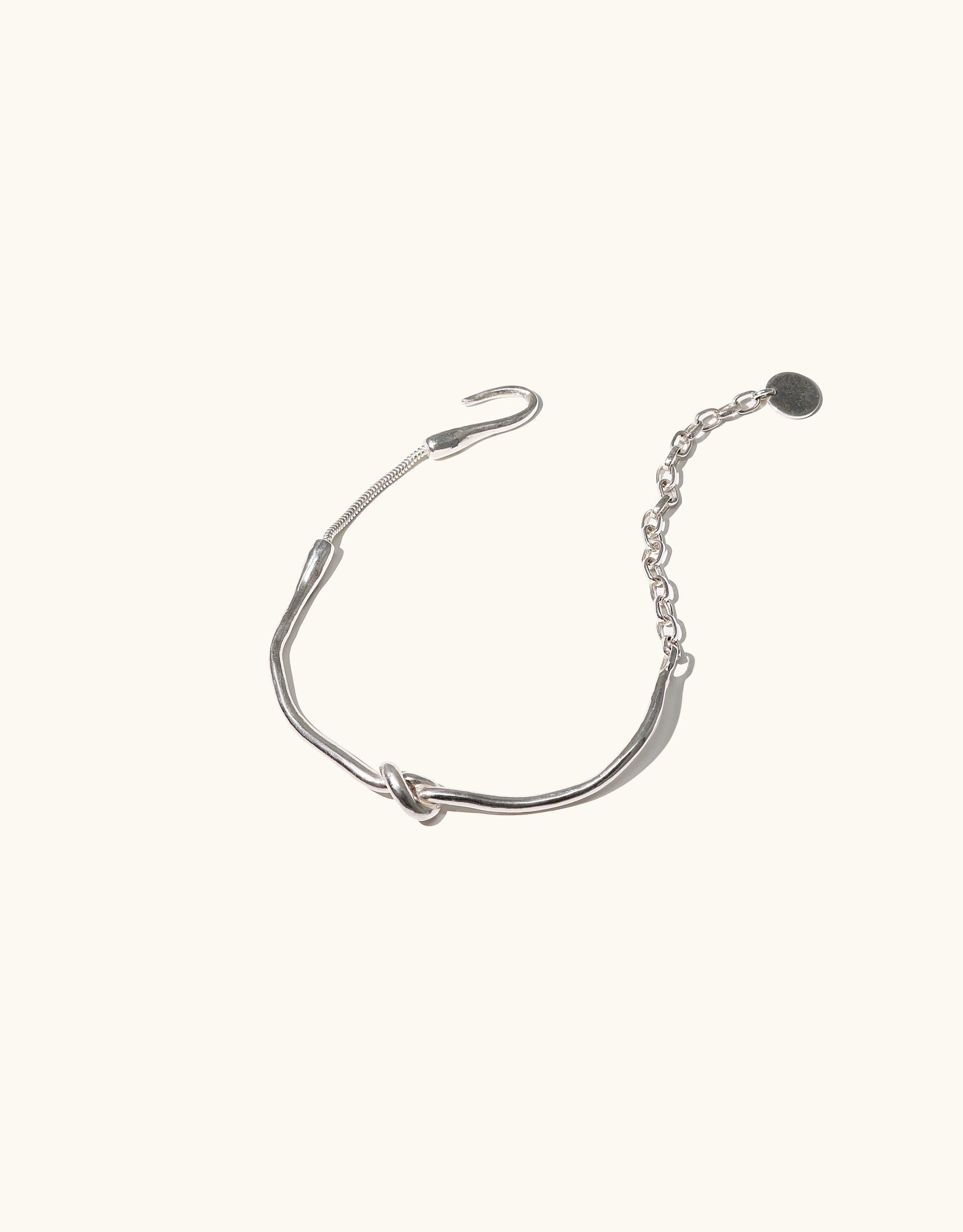 Elegant silver Single Rope Hook Bracelet with knotted center and adjustable chain, inspired by canyon terrain. Sleek design for an edgy look, part of the Terrain Collection. Handcrafted in Los Angeles. CLED