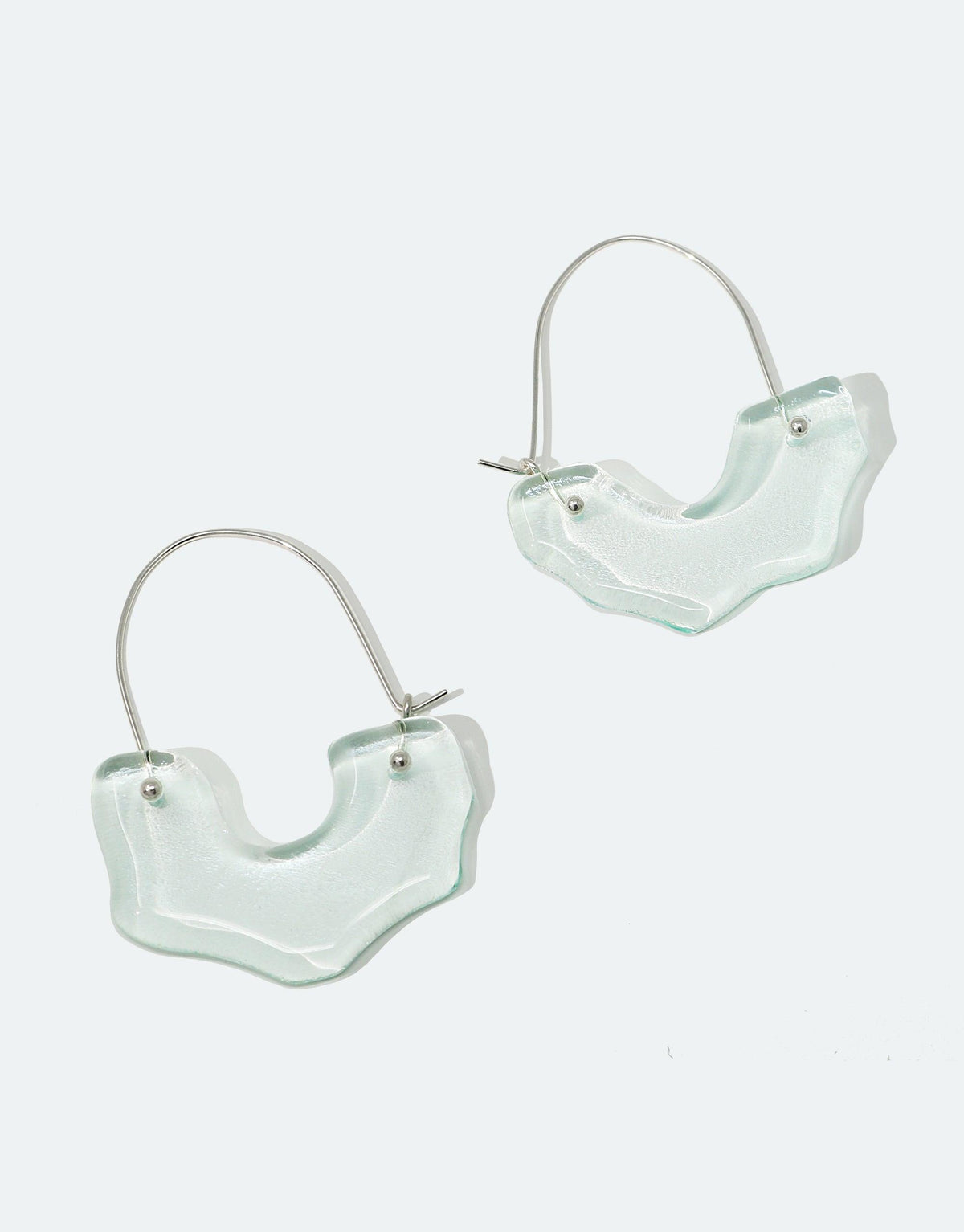 Polar Arch Hoop Earrings featuring abstract iceberg-shaped Eco Gem pendants made from repurposed glass bottles, suspended on silver hoops. Handcrafted sustainable jewelry inspired by Arctic landscapes, raising climate change awareness. CLED