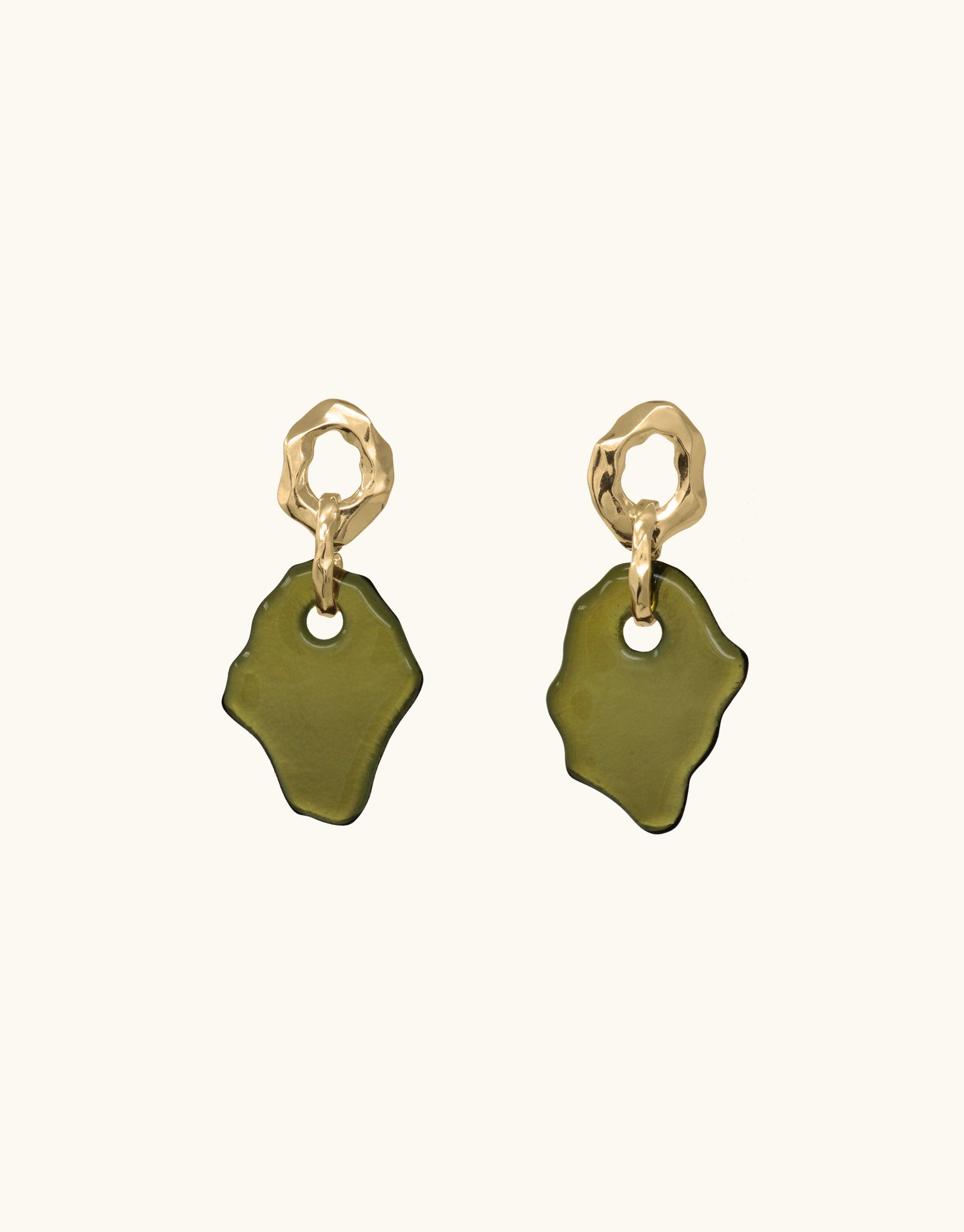 Canyon Earrings featuring organic gold-toned metal shapes with attached olive green glass pendants, inspired by canyon terrain. Handcrafted eco-friendly earrings made from repurposed glass bottles. Unique, abstract design showcasing layers and molten forms. CLED Canyon Earrings.