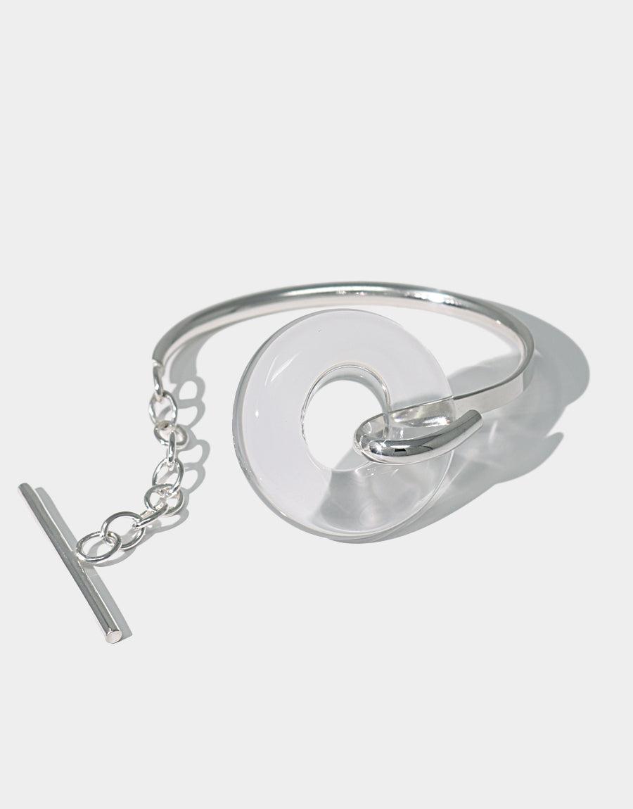 Sterling silver Opening Torus Toggle Bracelet featuring a unique repurposed glass circular element on a cuff with toggle closure. Elegant and timeless design showcasing sustainable jewelry craftsmanship. Handmade in Los Angeles by CLED.