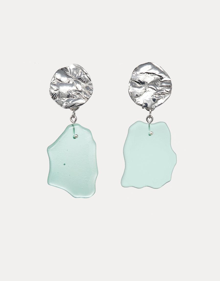 Coastline Earrings | Small Drop: Elegant sterling silver earrings with textured circular studs and sea glass-inspired pale blue drops. Handcrafted eco-friendly jewelry featuring repurposed glass. Unique coastal-inspired design perfect for beach lovers. CLED