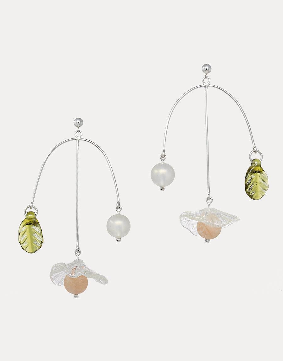 Elegant Floral Cluster Earrings featuring delicate arch design with suspended glass flower, pearlescent bead, and green leaf accent. Handcrafted sterling silver earrings showcase eco-friendly repurposed glass elements. Perfect for nature-inspired, sustainable jewelry lovers. CLED Floral Cluster Earrings.