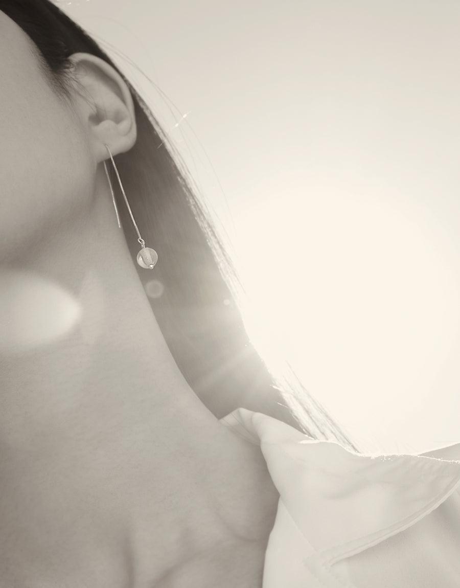 Elegant Minimal Line Earrings featuring delicate sterling silver chain and small glass Eco Gem, shown worn on ear. Subtle and sophisticated design for everyday wear. Handcrafted sustainable jewelry by CLED.