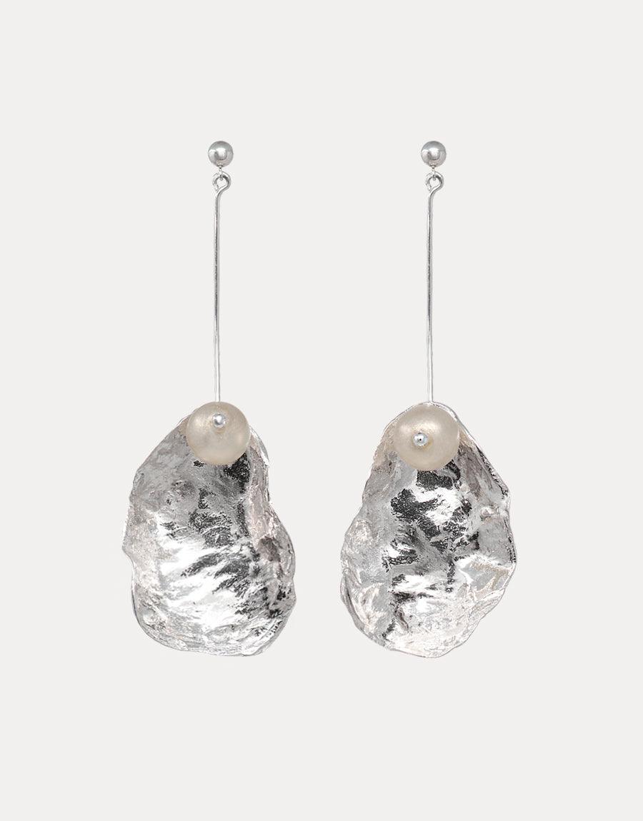 Sustainable dangle earrings featuring textured metal shells with Eco Gem pearls made from recycled glass bottles. Sterling silver orb posts with long, elegant drop design. Handcrafted, eco-friendly alternative to traditional pearls. Not A Pearl Earring by CLED.