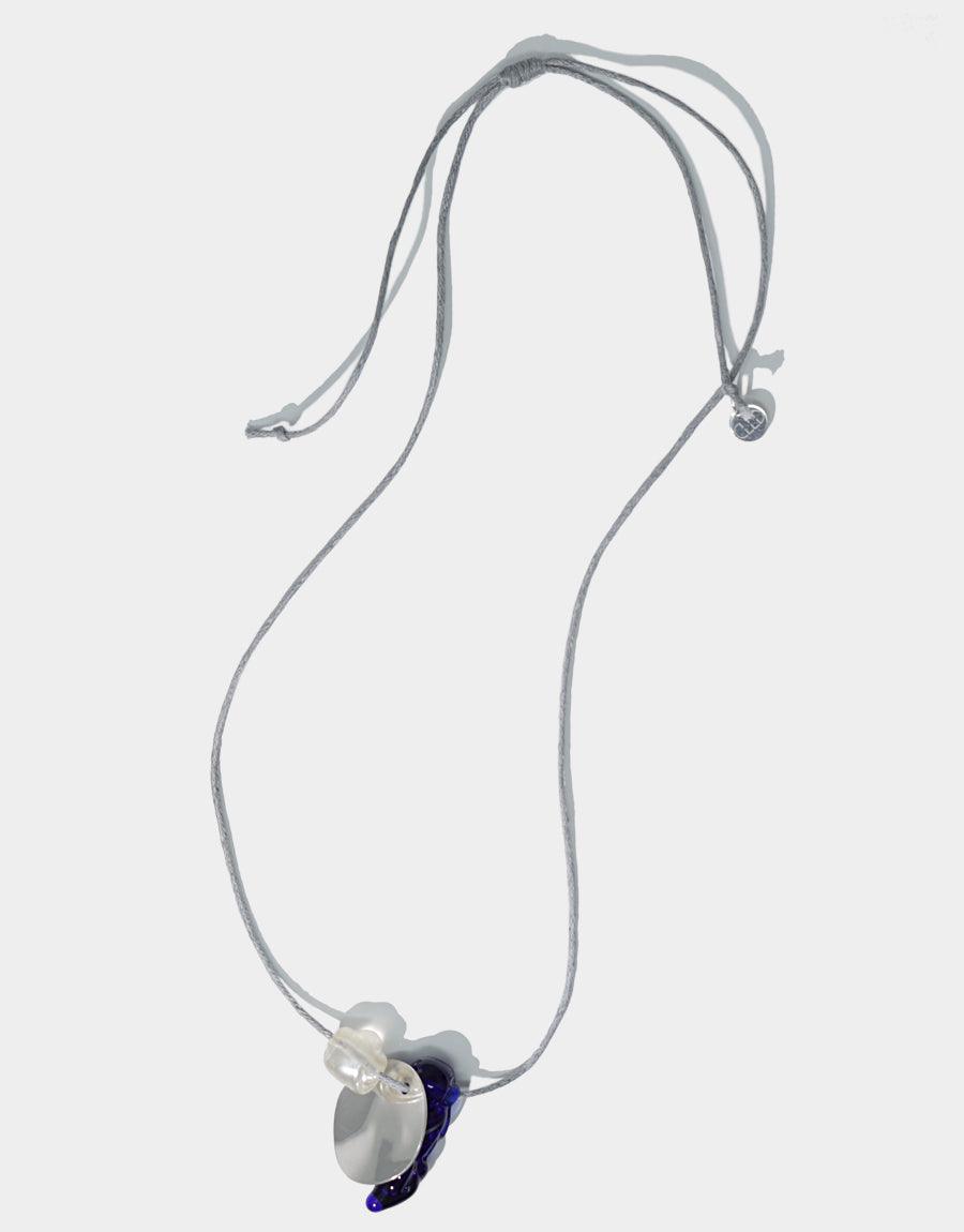 Amorphous Long Cluster Necklace featuring adjustable grey cotton cord with three unique charms: white pearl, blue amorphous gem, and wavy disc. Handcrafted sterling silver necklace showcasing repurposed glass gems. Elegant and versatile accessory by CLED.