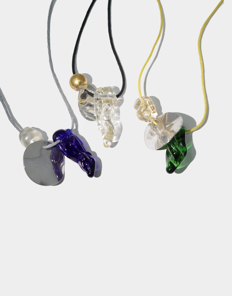 Three Amorphous Long Cluster Necklaces with colorful glass charms and metallic accents on adjustable cotton cords, showcasing unique handcrafted designs with repurposed glass gems and pearl details. Sustainable and versatile jewelry piece. Amorphous Long Cluster Necklace by CLED